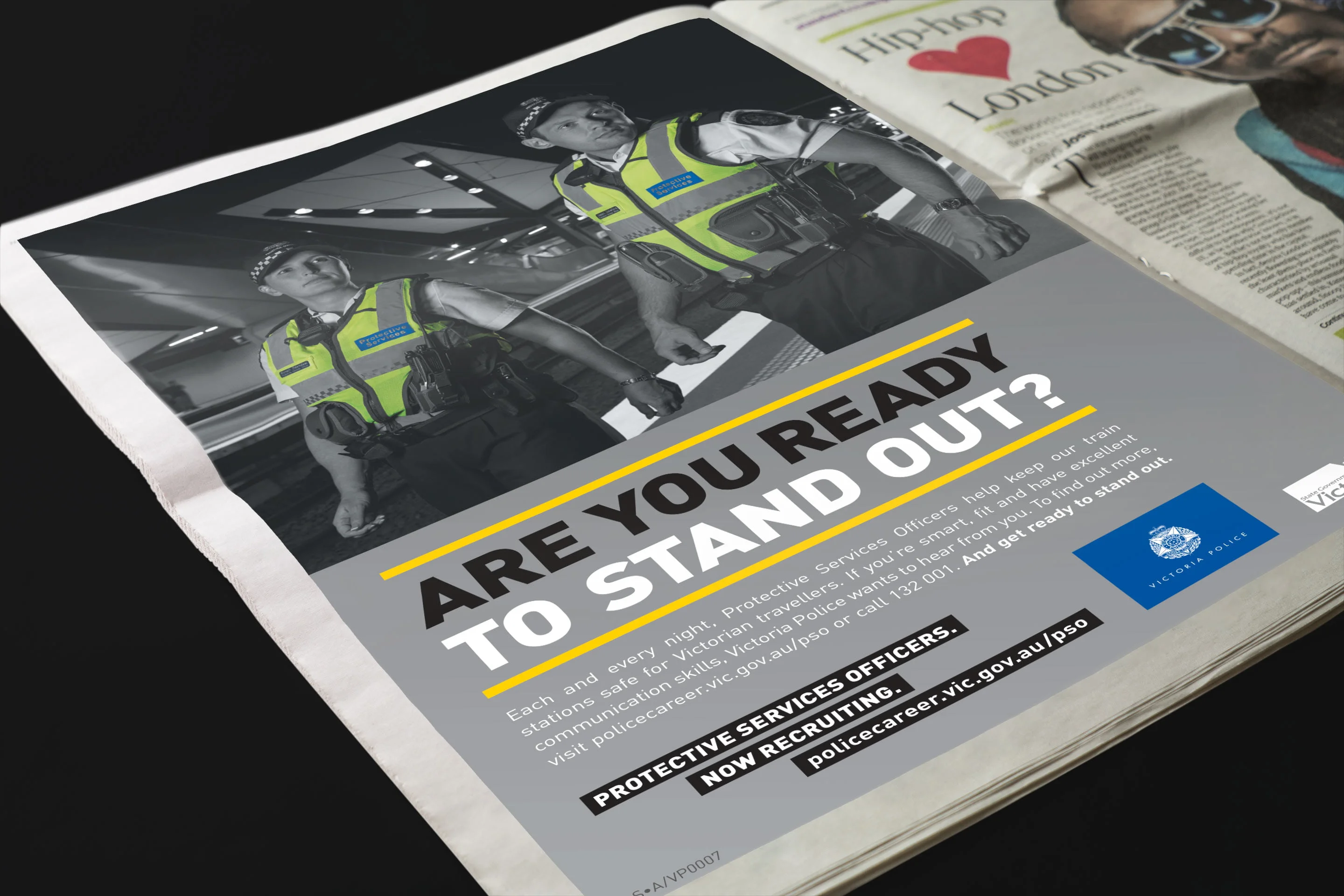 Newspaper ad in black and white with two protective services officers and 'Are you ready to stand out?' for Victoria Police