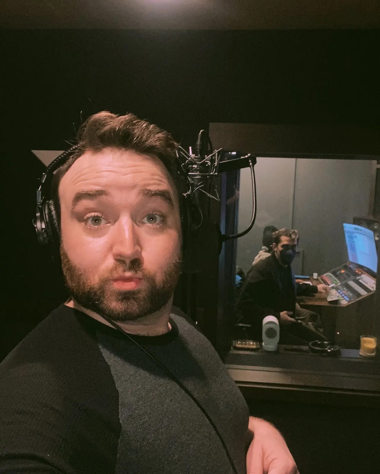 Recording booth selfie with engineer in the background