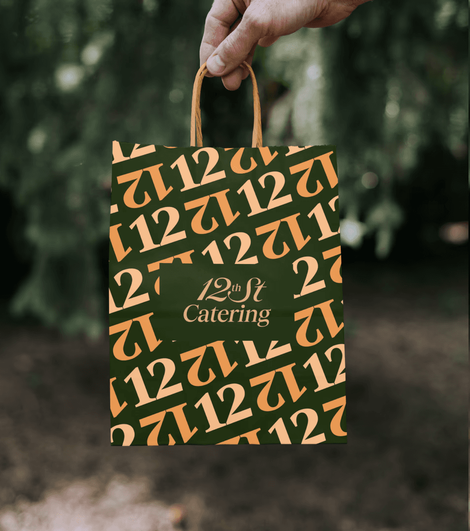 Black and white image of people working at a table with laptops, showing hands gesturing during discussion of digital content displayed on screens, with fabrica® logo in the corner.