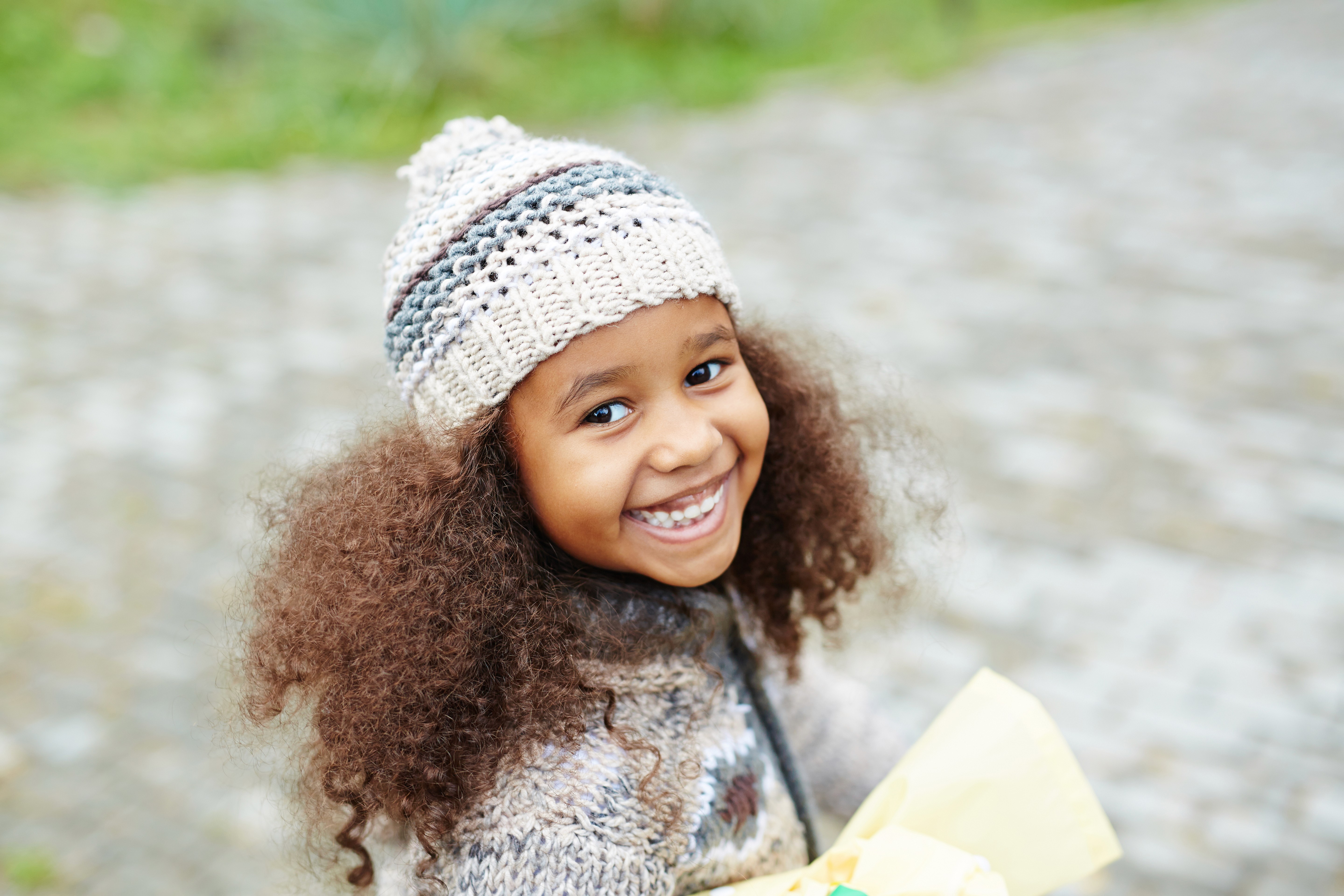Girl wearing a beanie and smiling