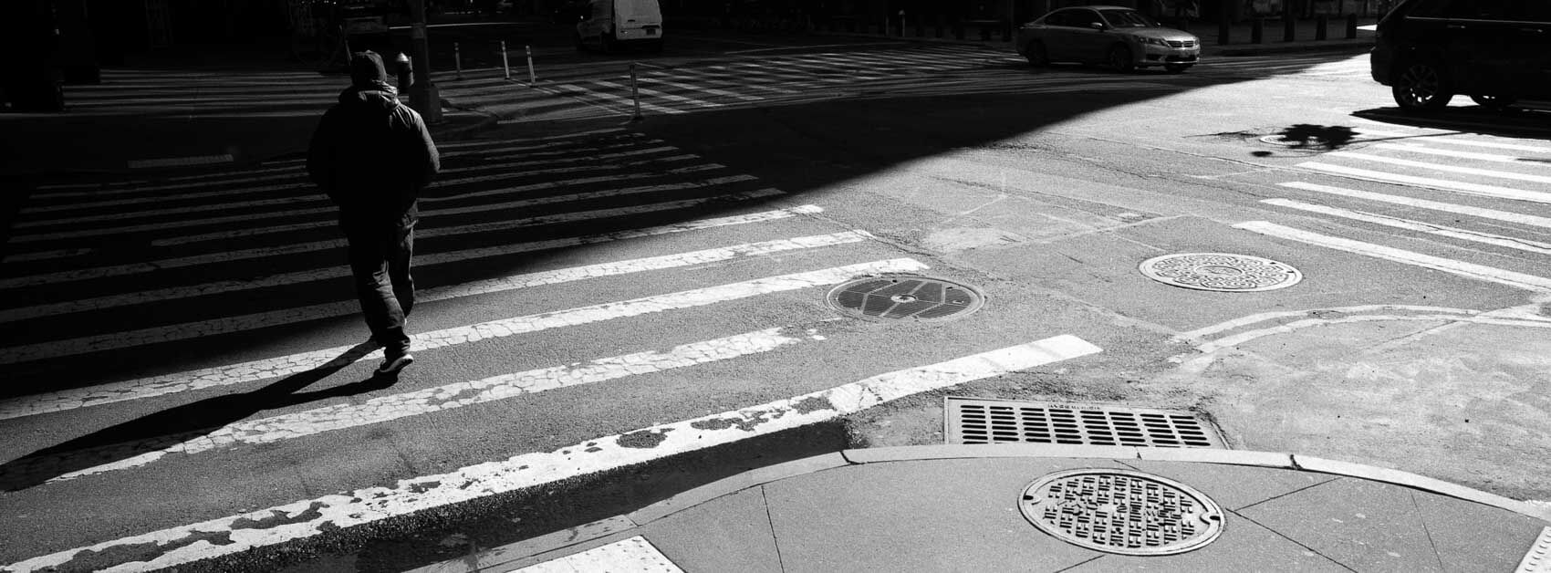 NYC pictures black and white with long shadows in the middle of Manhattan, panoramic Hasselblad XPan patterns patience.