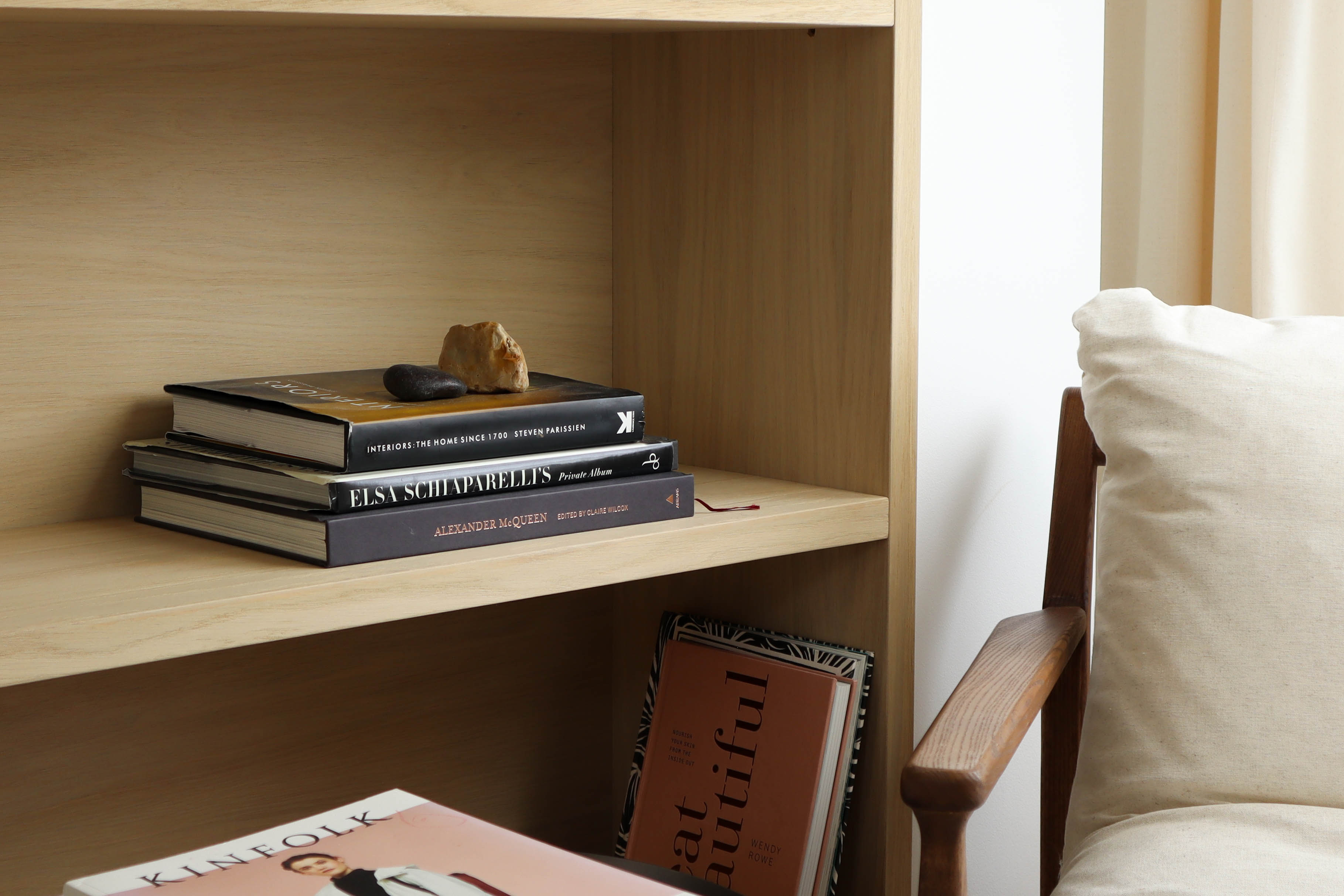 Airbnb photography bookcase with decorative books and reading chair