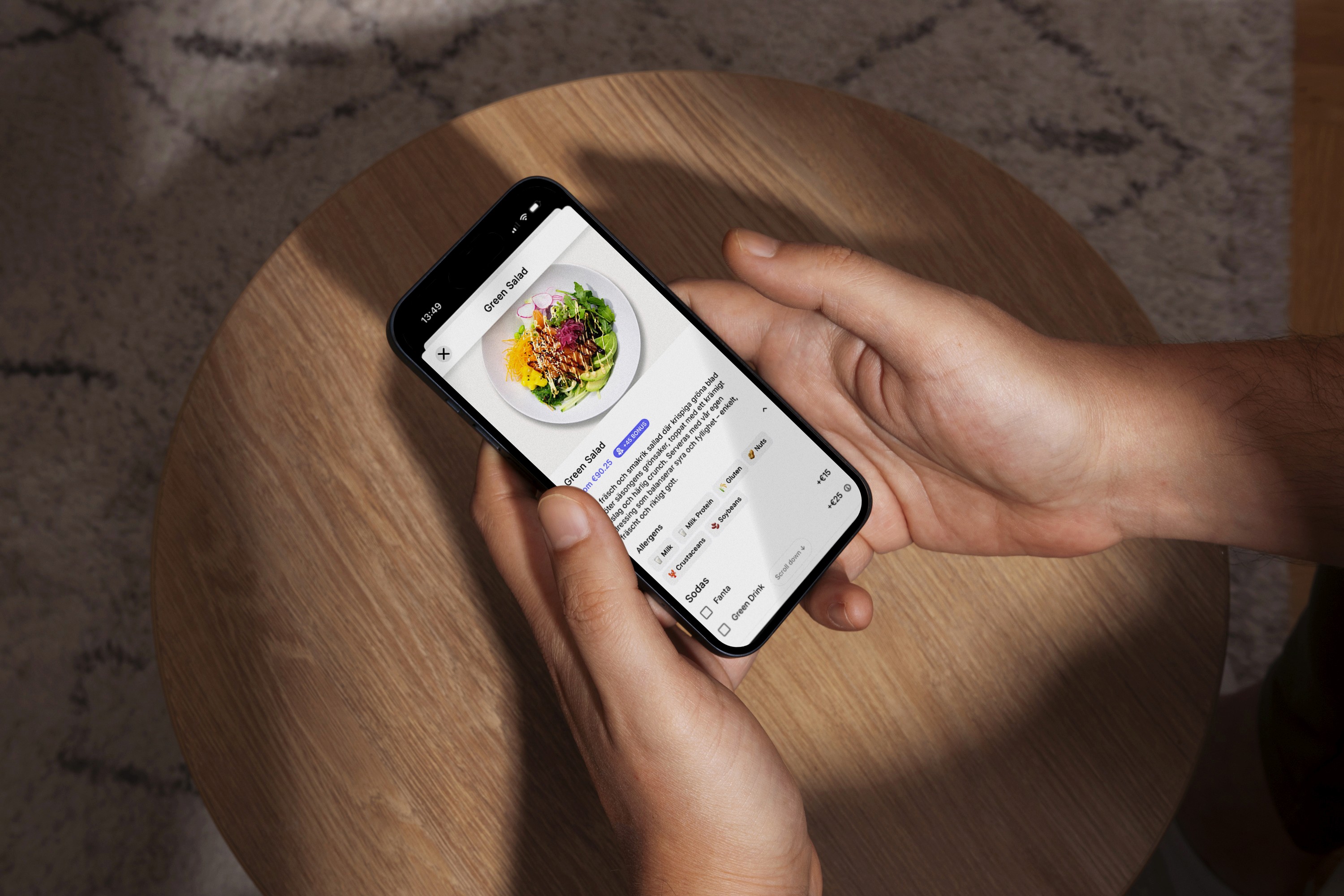 Person using food delivery app on smartphone to order a salad.
