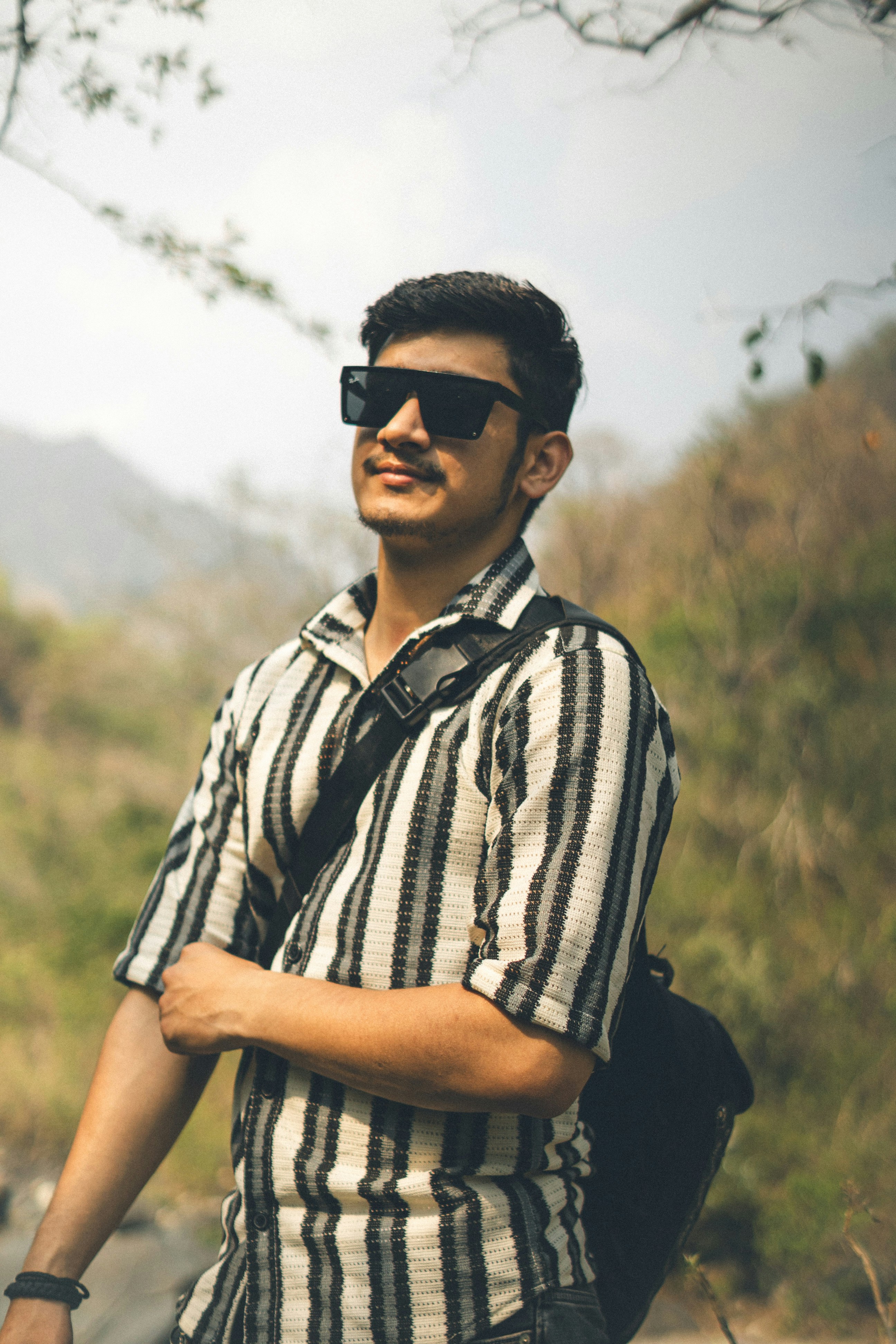 a man with a backpack and sunglasses on