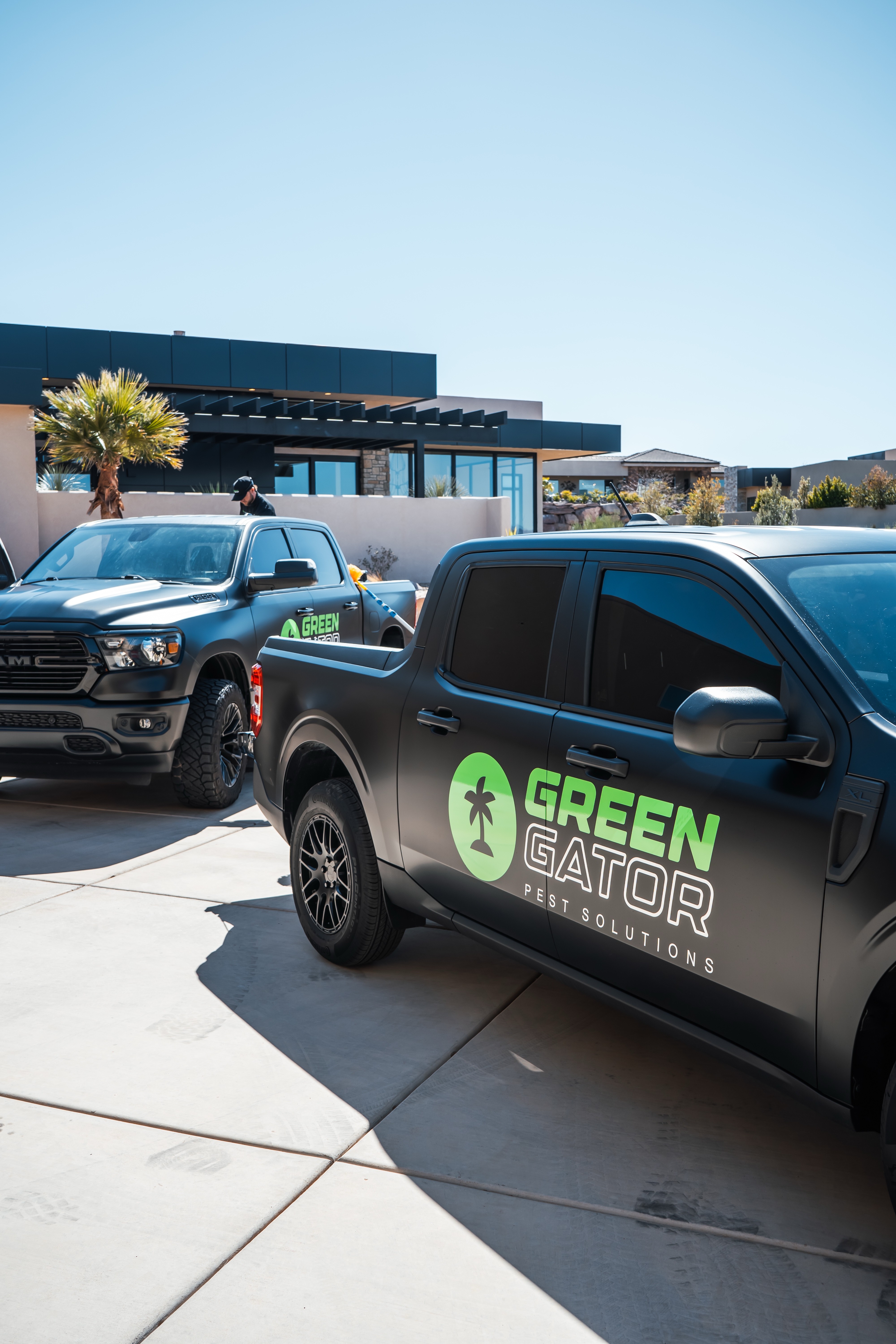 Hero Image 2 - Two pest control trucks on a driveway