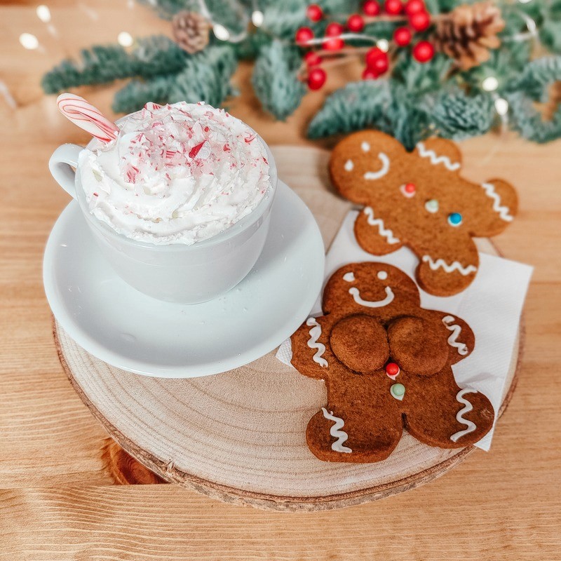 Gingerbread cookies with a festive Christmas drink on a table.
