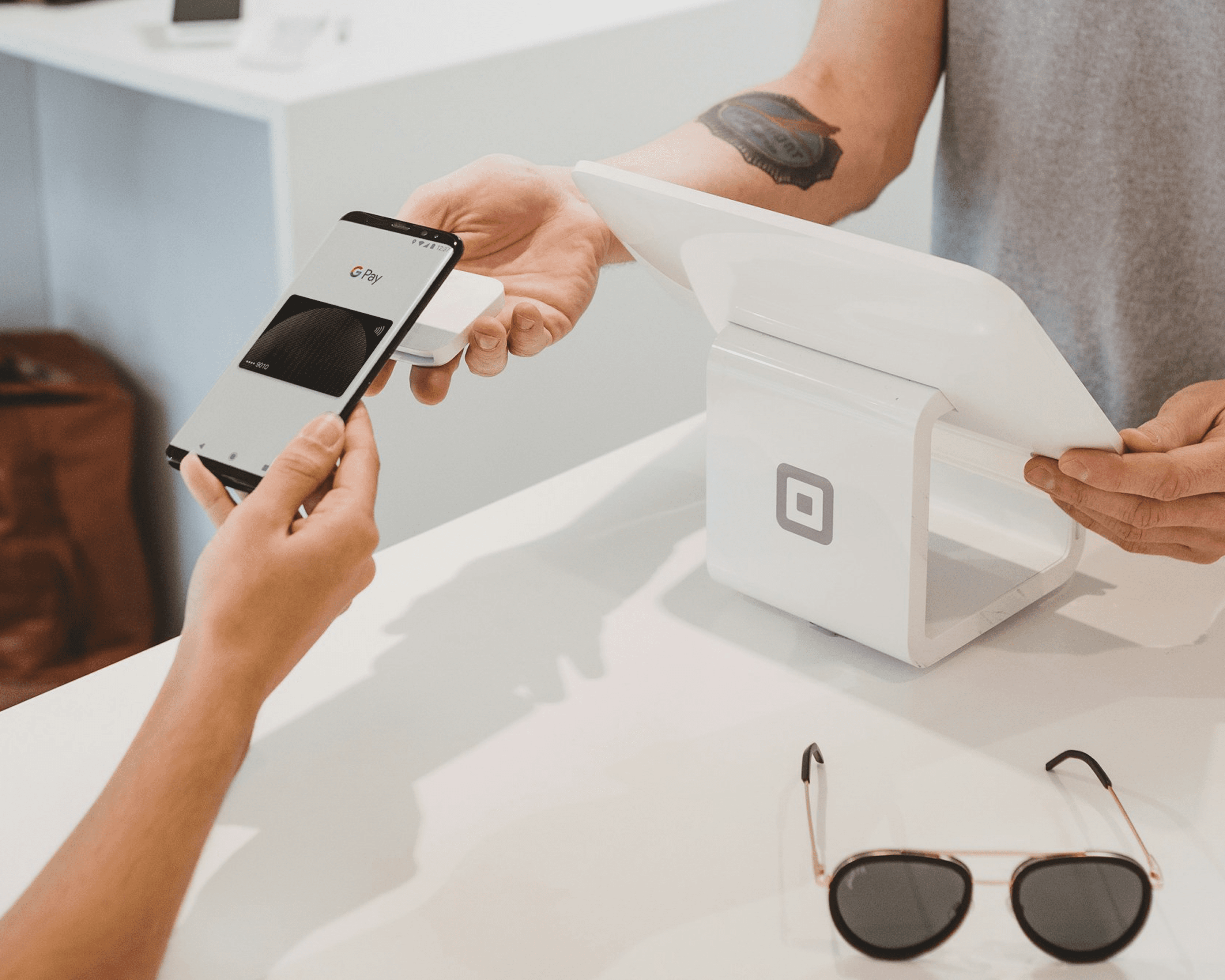 Smartphone with Google Pay making contactless payment at Square terminal
