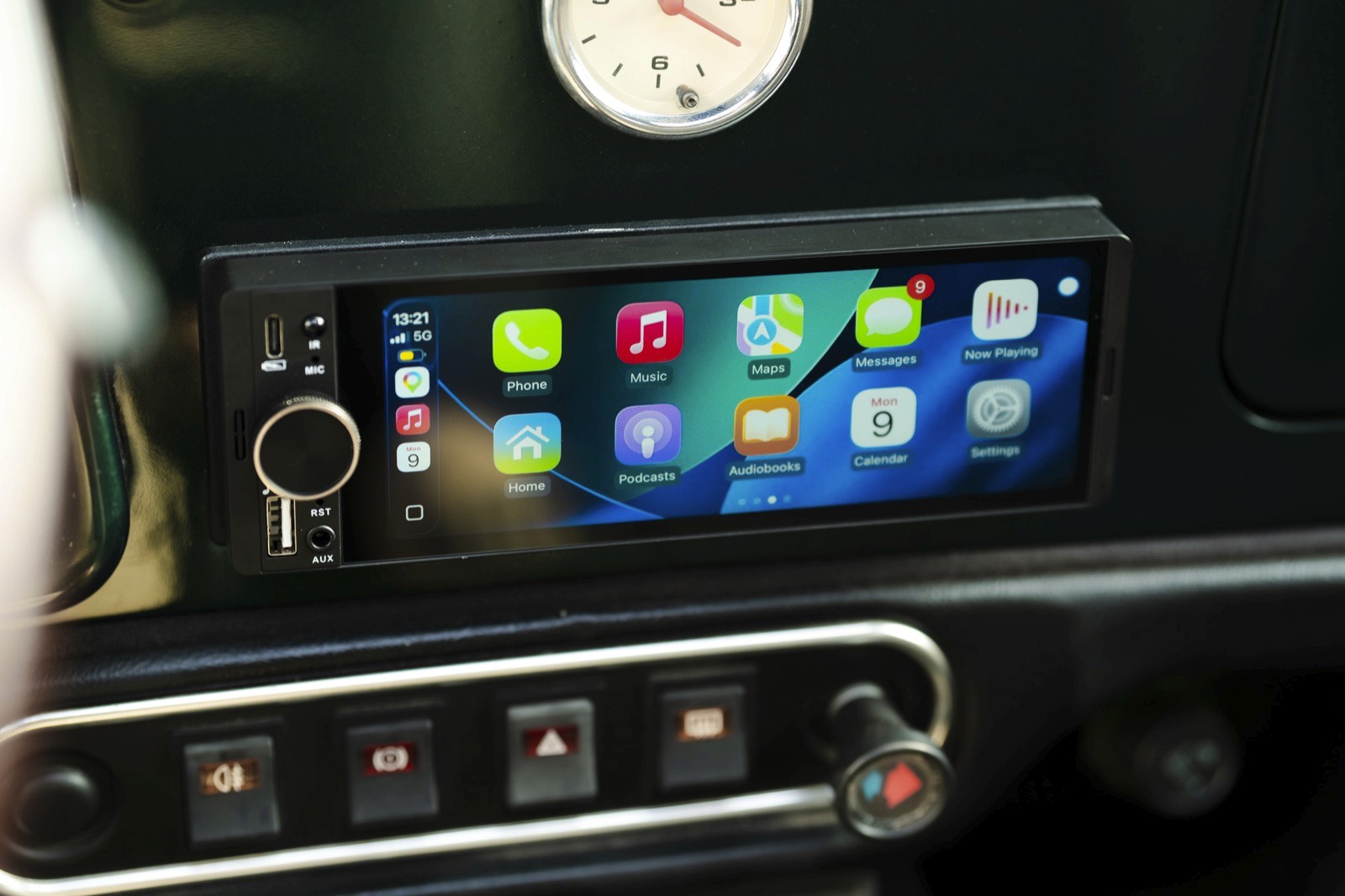 A close-up of a car dashboard featuring a digital display with various colorful app icons.