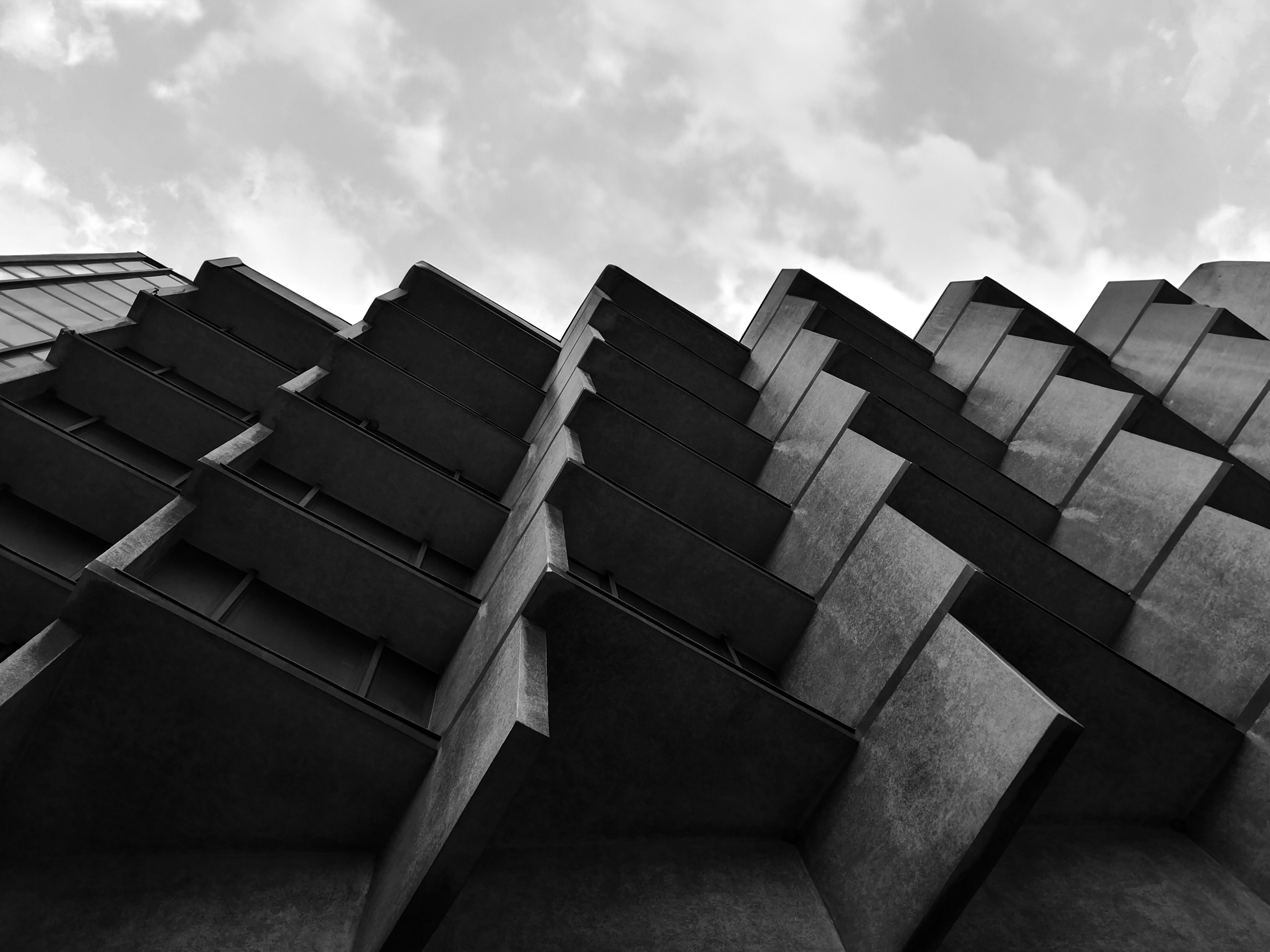 Person sitting on a ledge overlooking New York City skyline