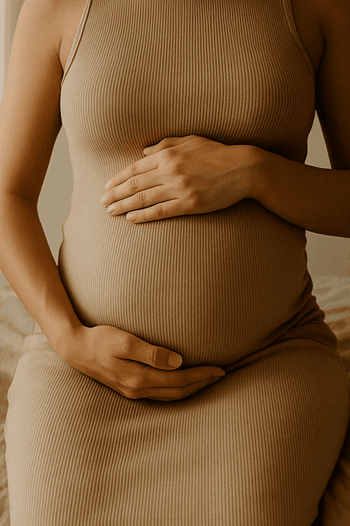 Close-up of a dark green leaf showing its textured surface and central vein against a muted background.