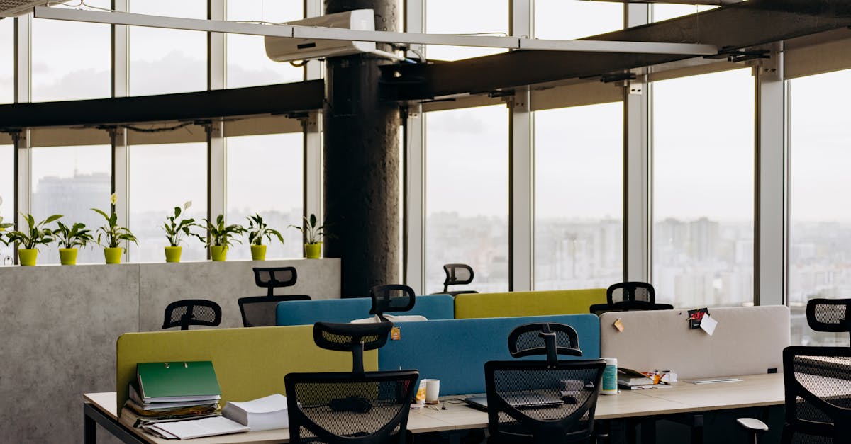 A spacious open office with colorful dividers, large windows, and a cityscape view, perfect for crea