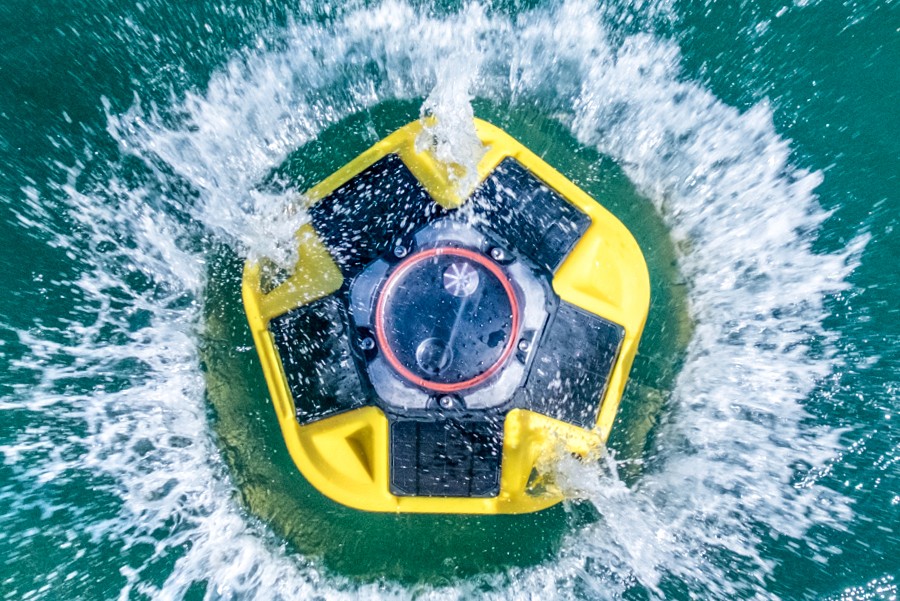 Sofar ocan spotting buoy dropped into ocean water.