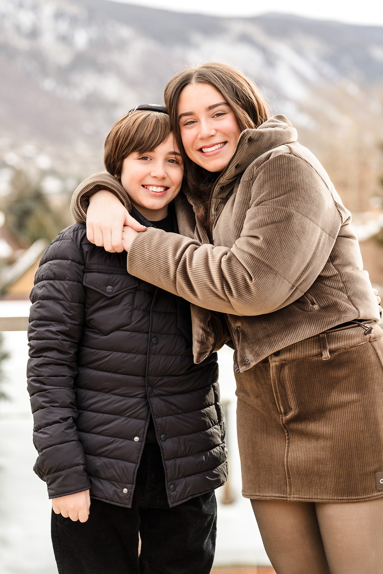 Mother and son sharing a hug before a bar mitzvah ceremony