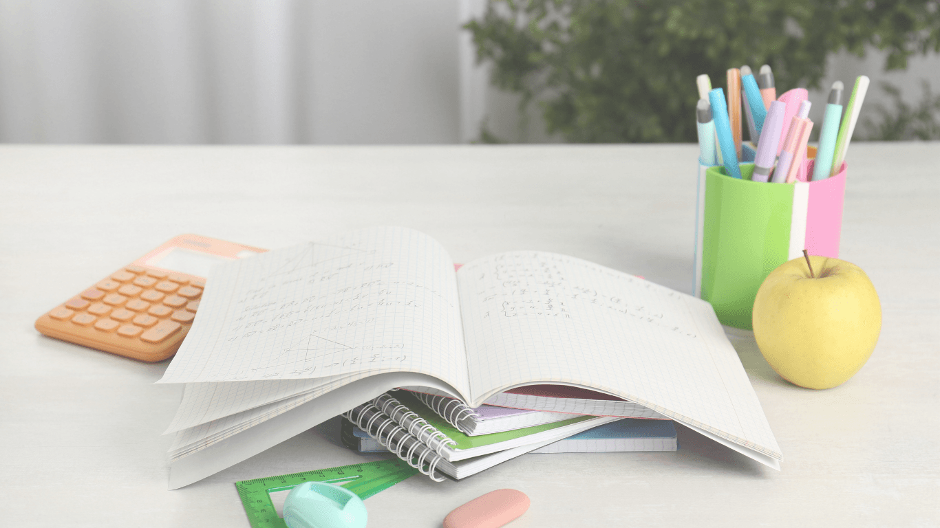 Open notebook with handwritten math notes next to a calculator and pens, used to illustrate marketing fundamentals and human judgment in AI-powered marketing.