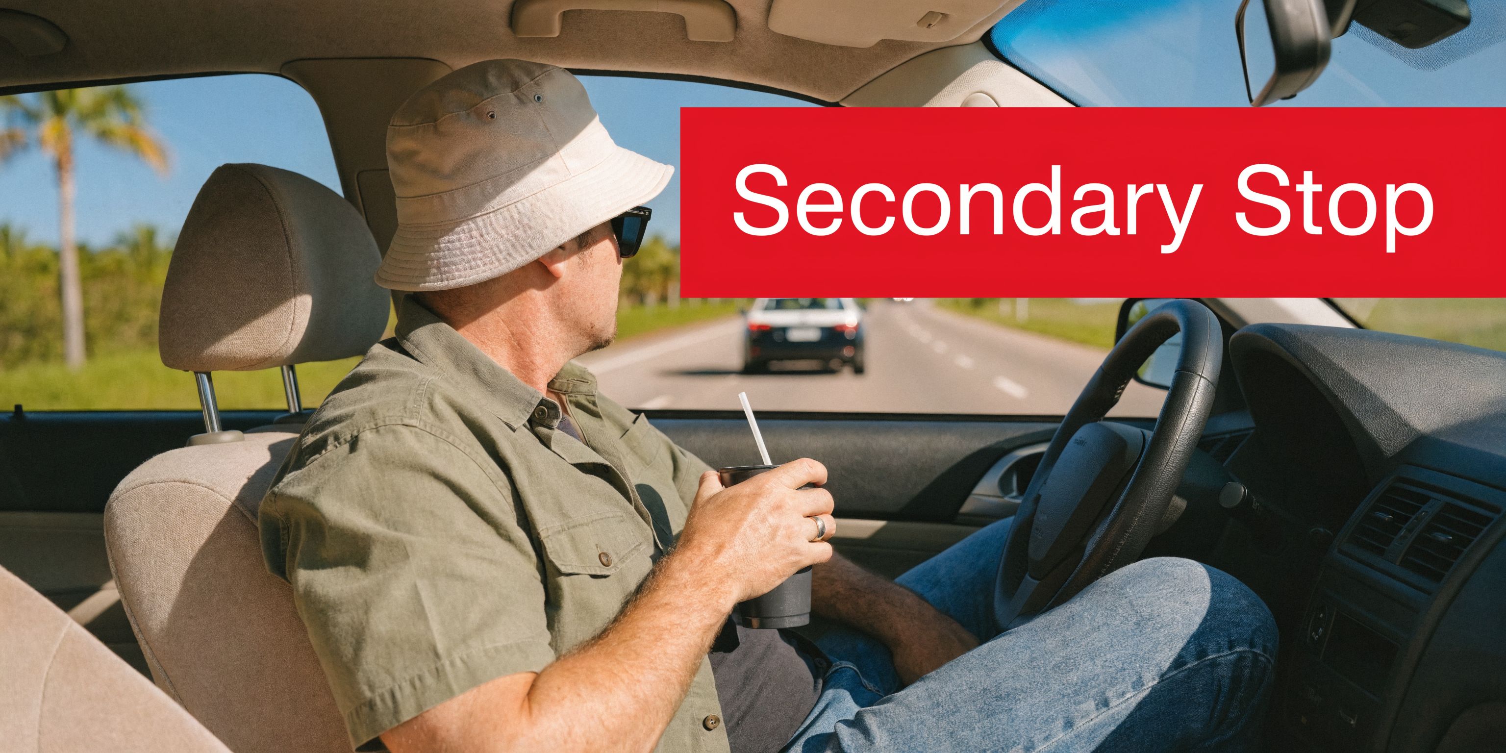 A man wearing a bucket hat driving a car while holding a beverage cup during daytime.