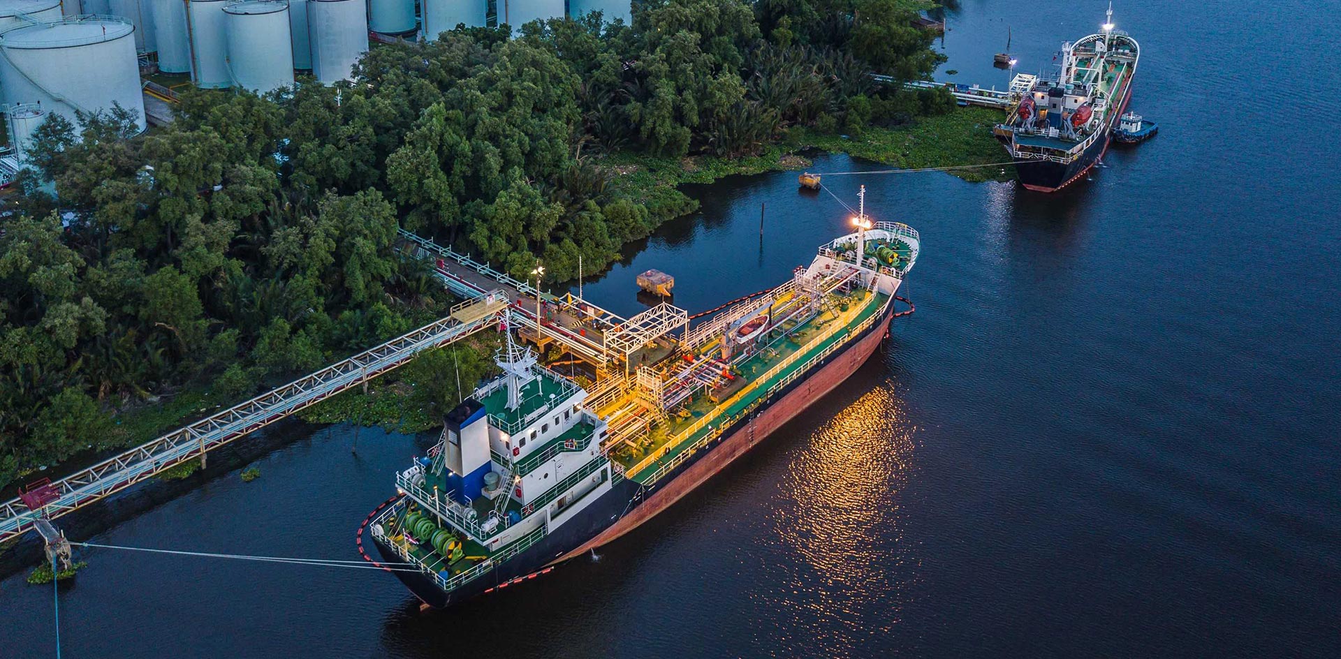 woman in blue tank top standing beside white wall