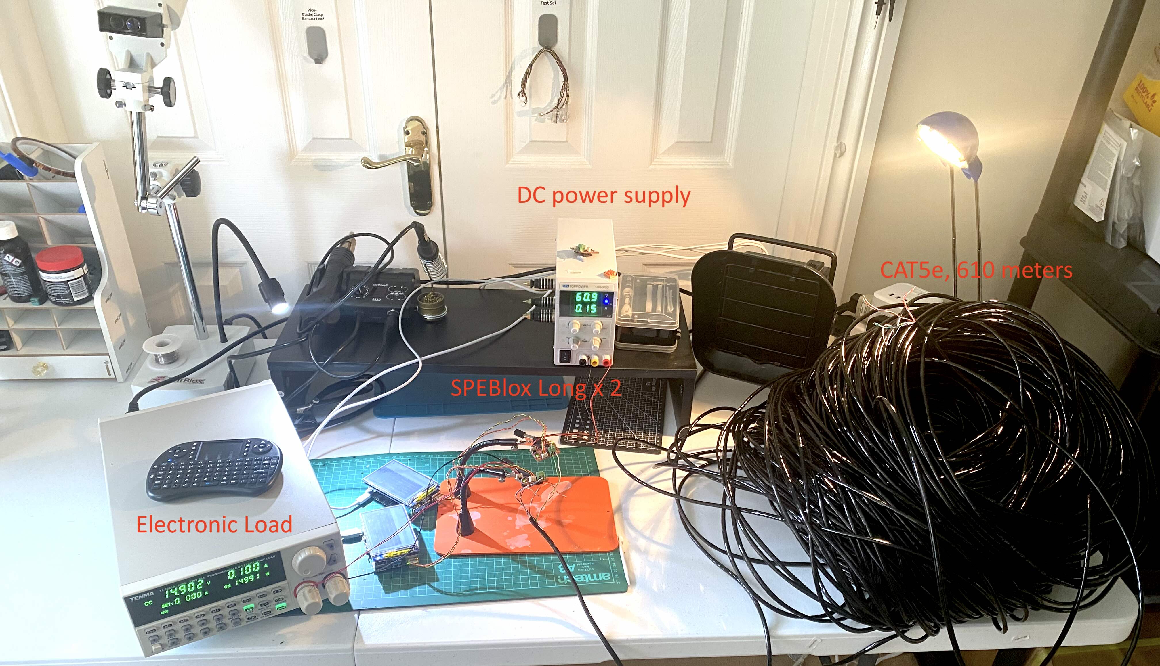PoDL test bench: two SPEBlox-Long units linked by 610 meters of coiled CAT5e, with DC power supply and electronic load