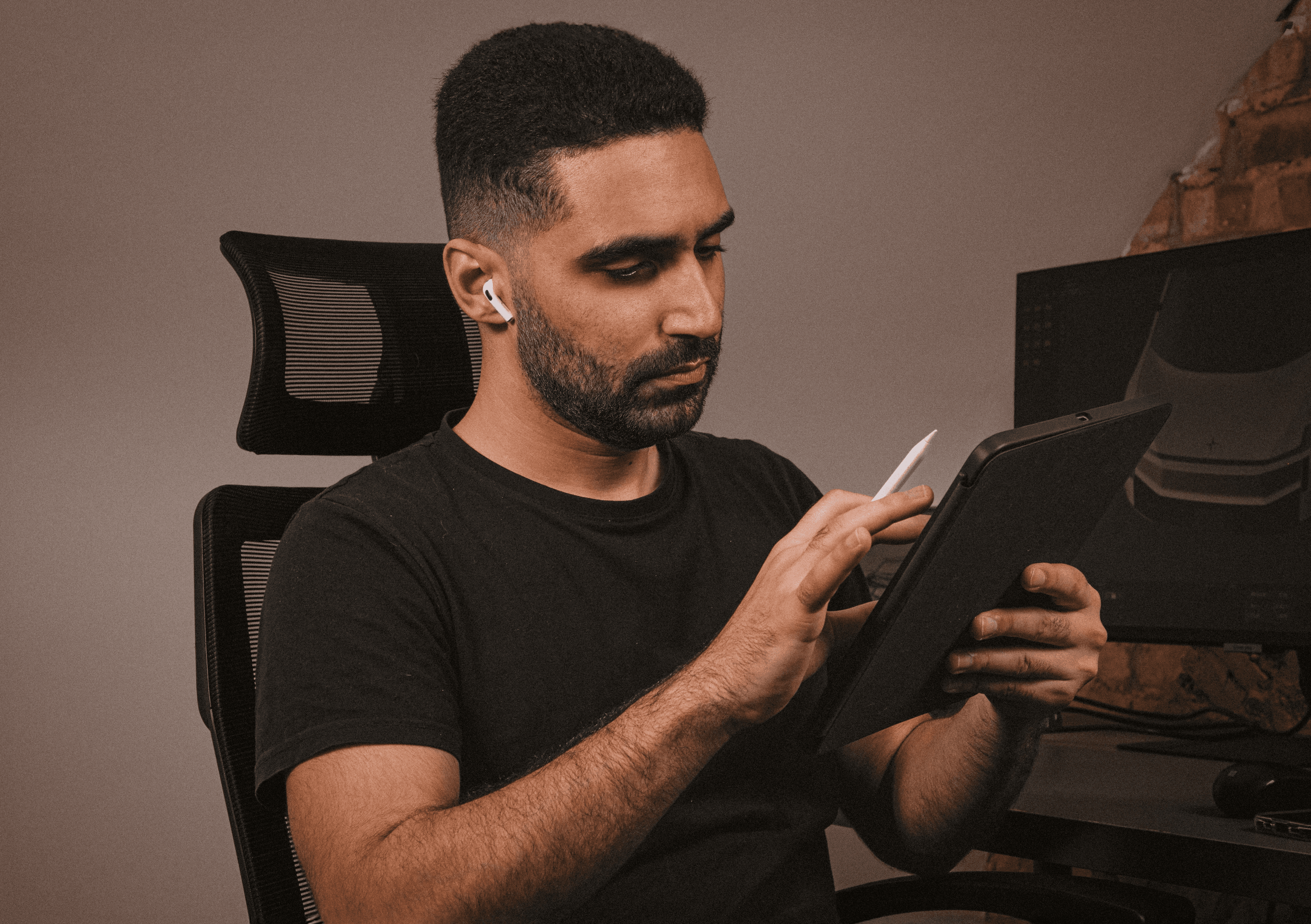A close-up of a person wearing green-tinted glasses, with a serious expression and smooth skin.