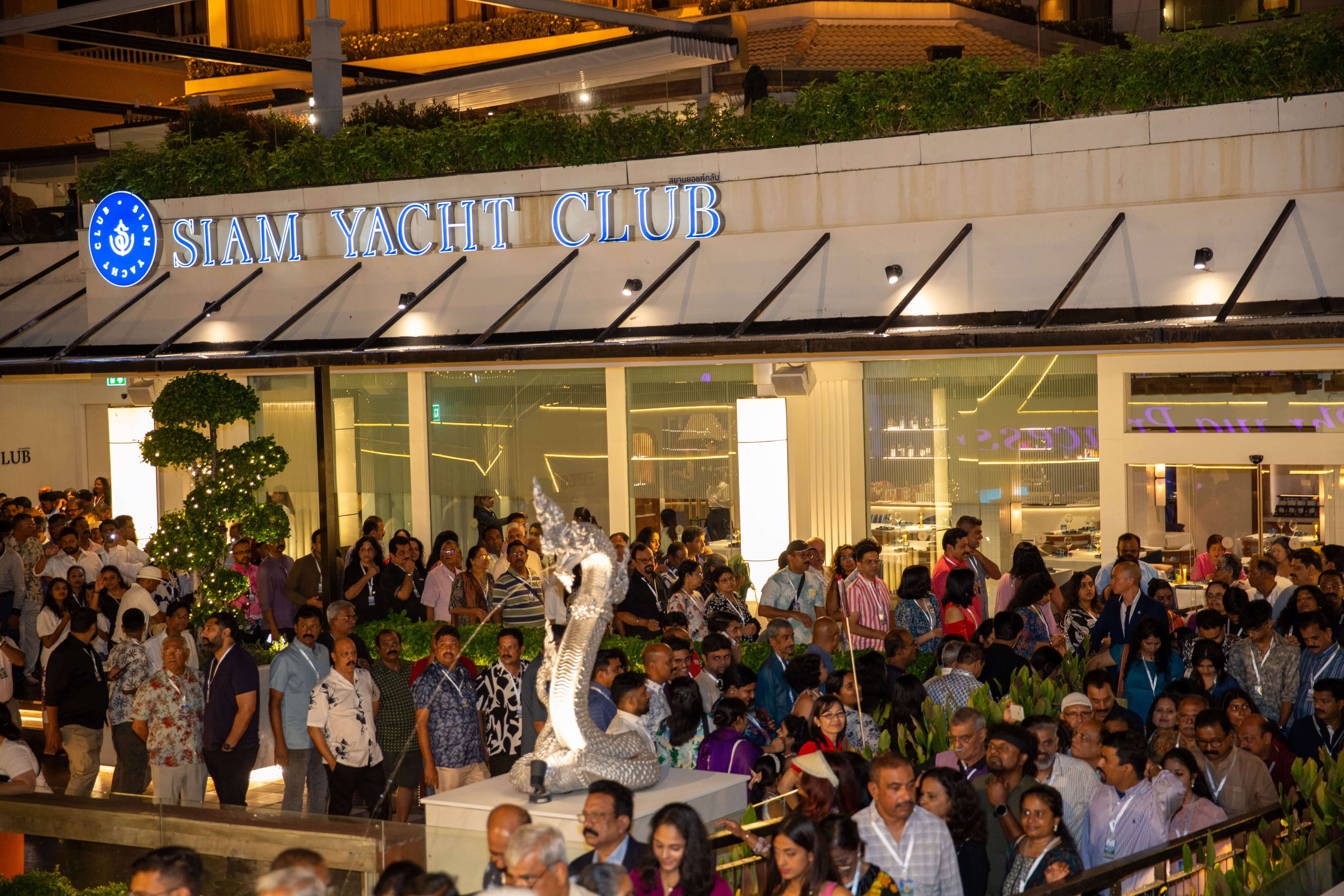 City skyline at night seen from a ferry deck.