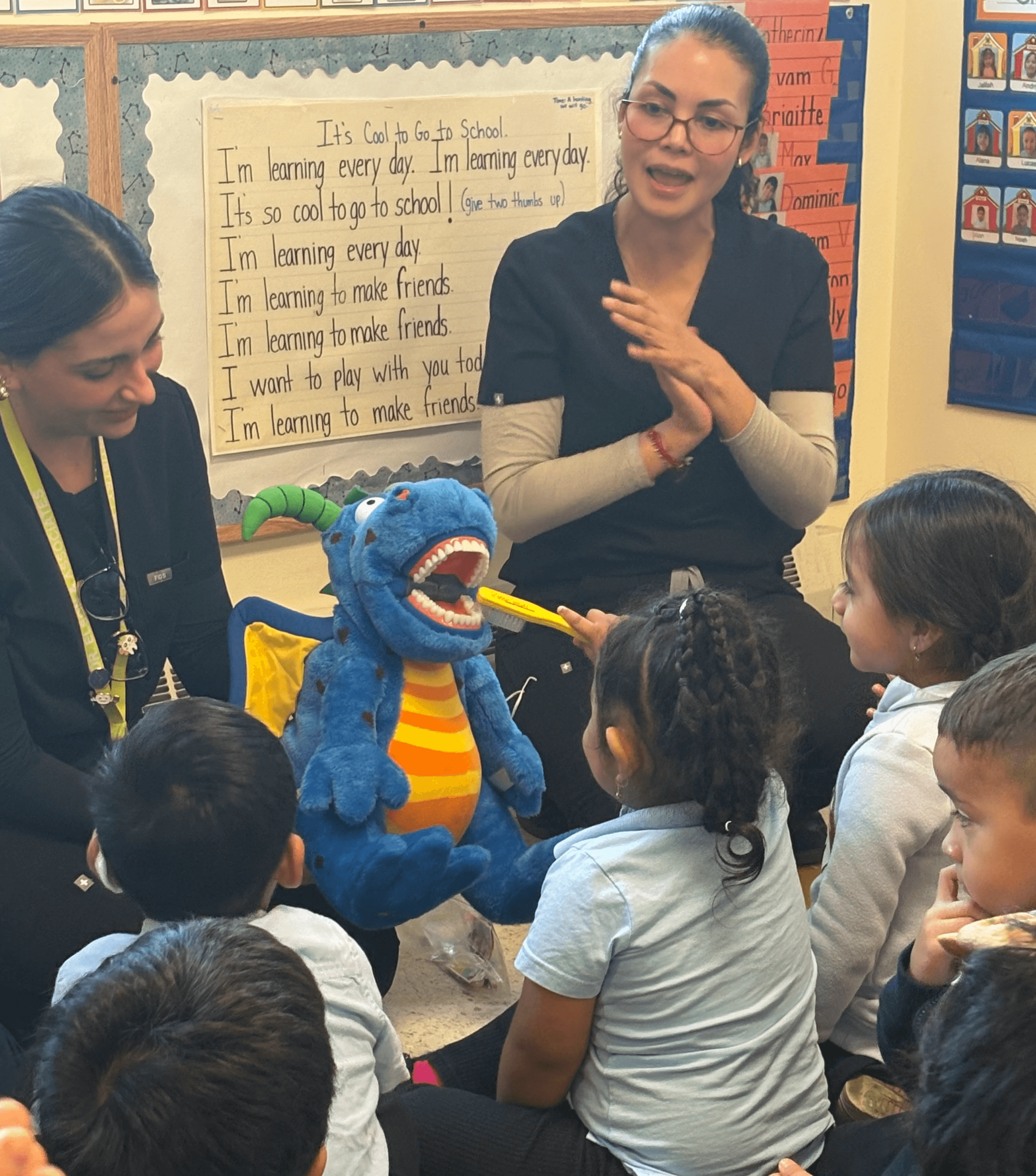 NYU Dental students demonstrate to preschoolers how to brush properly using a puppet. 