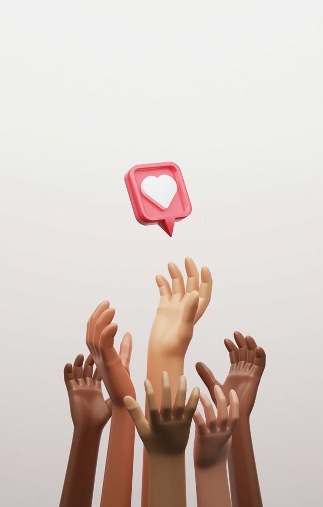 Multiple raised hands in various skin tones reach towards a floating 3D social media like icon, symbolizing the diverse pursuit of digital appreciation and engagement.