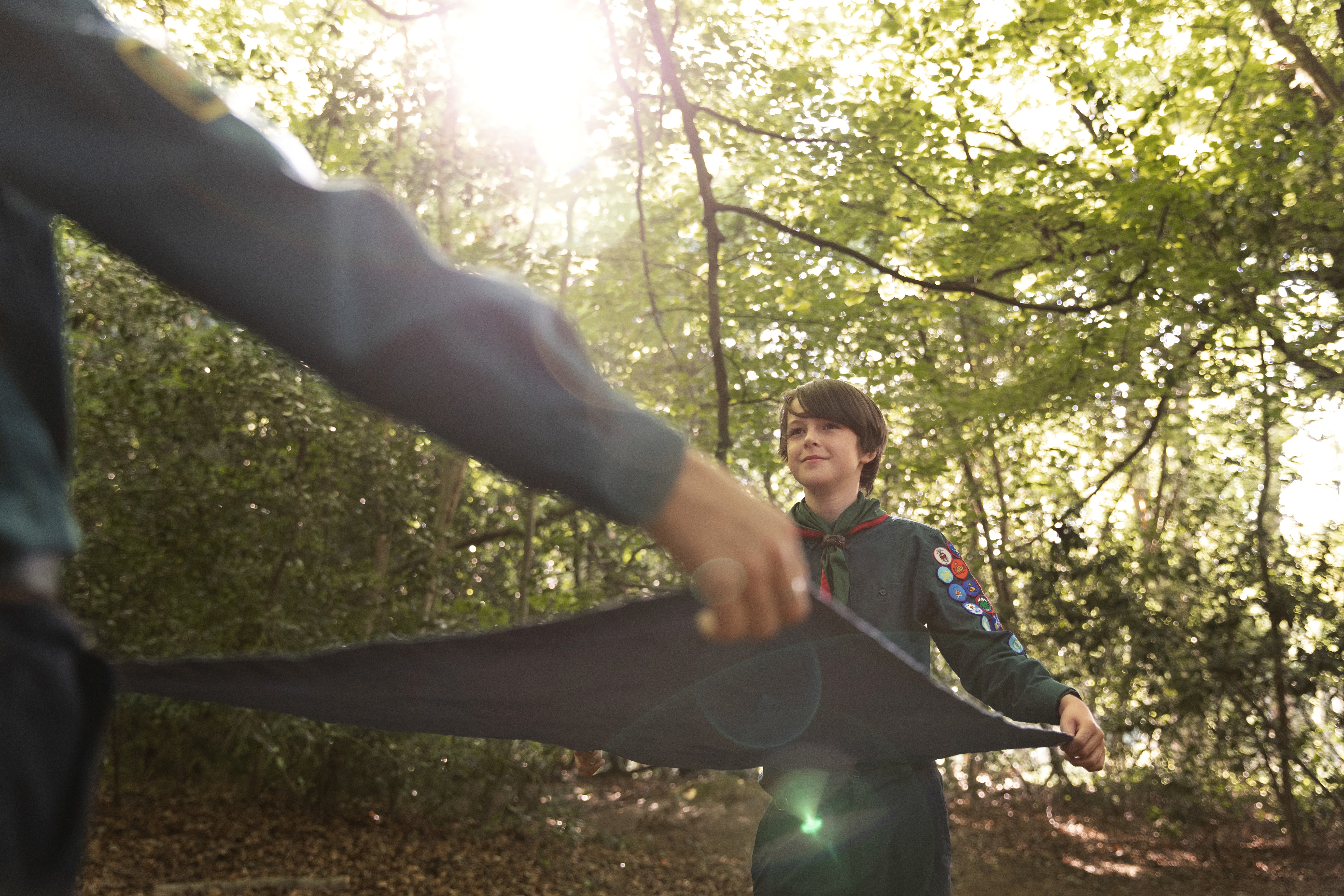 Snowboarder enjoys a downhill run on a sunny day.
