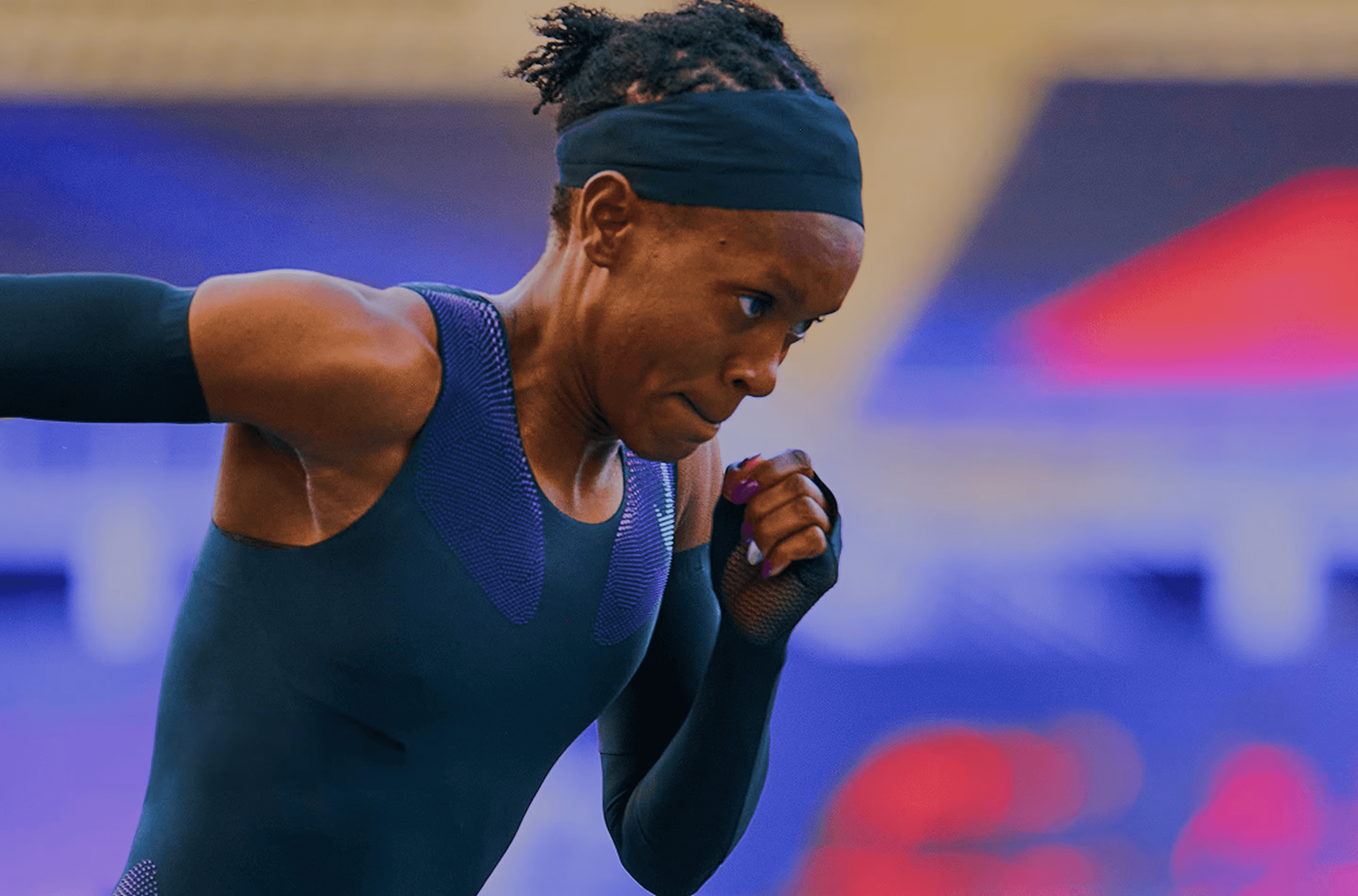 A woman running on a running track at night
