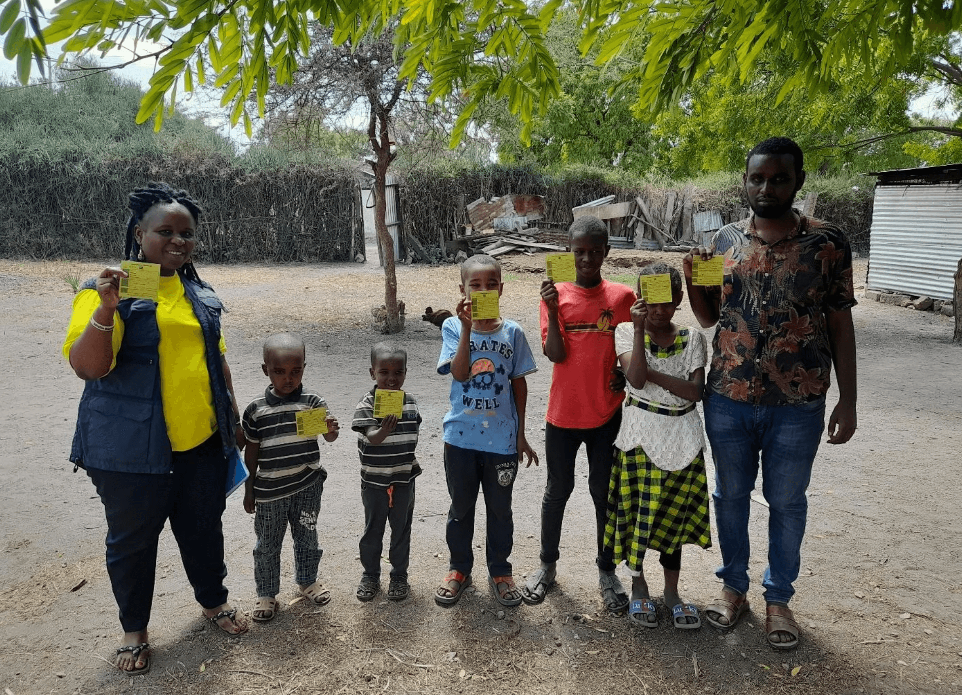 Three children jumping in burlap sacks during a race.