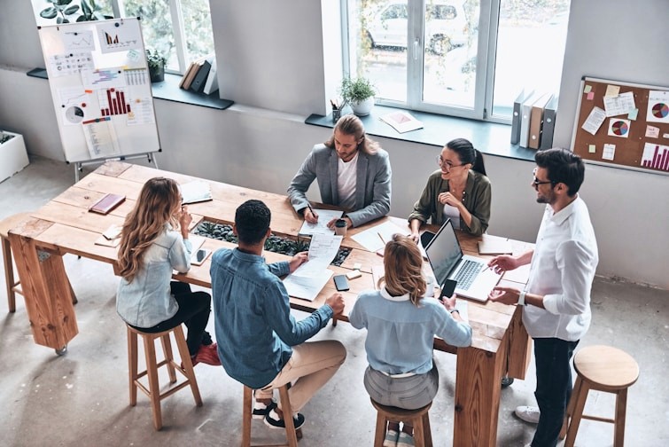 Team members having a meeting around a large table