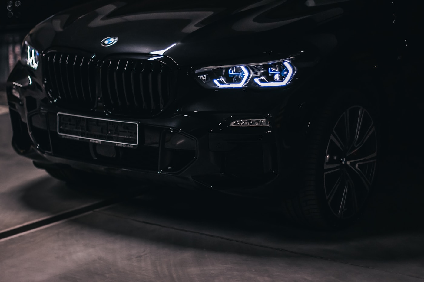 Black luxury SUV photographed after detailing with deep glossy reflections