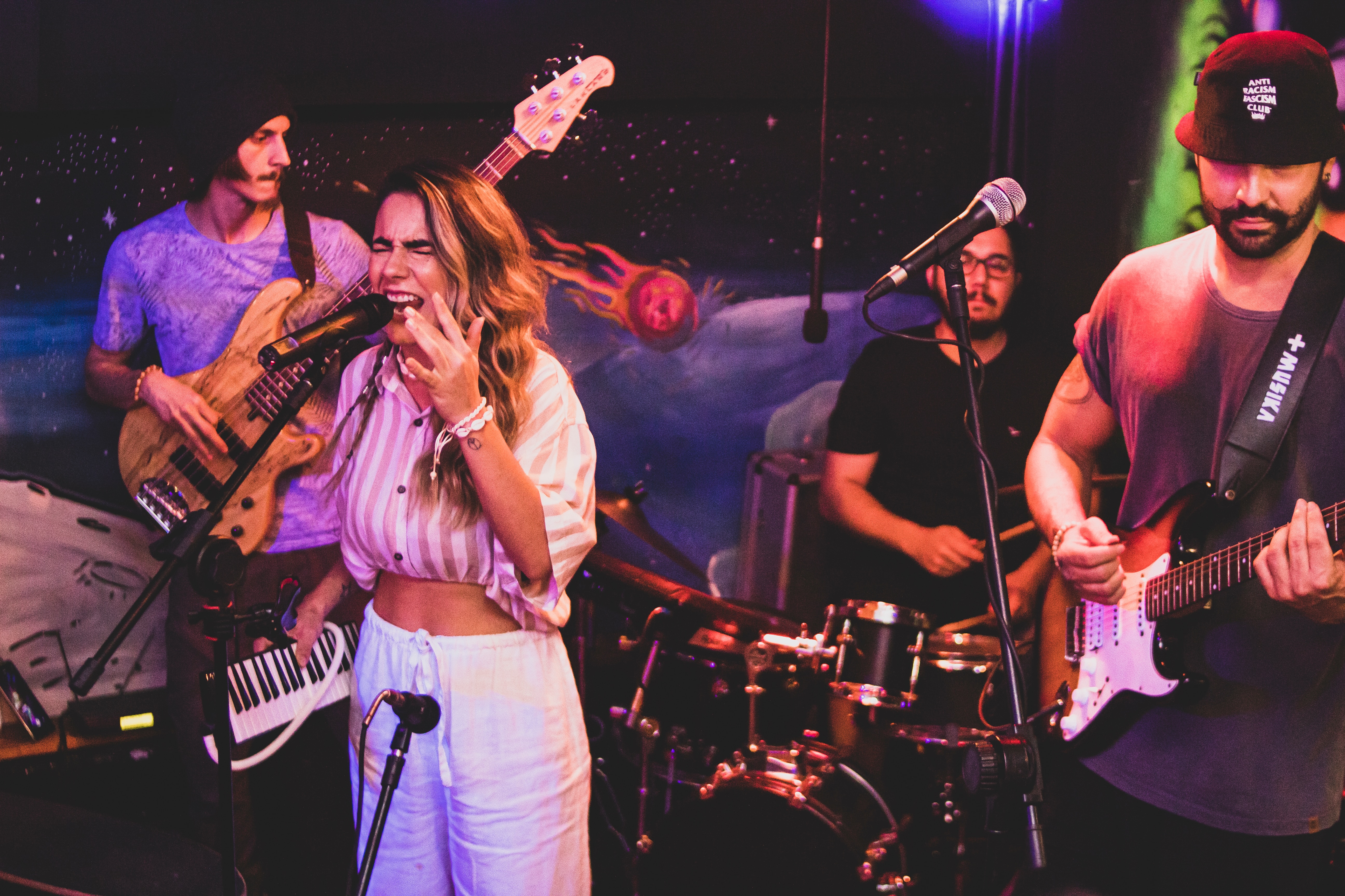 A small band performing on stage - different voice types