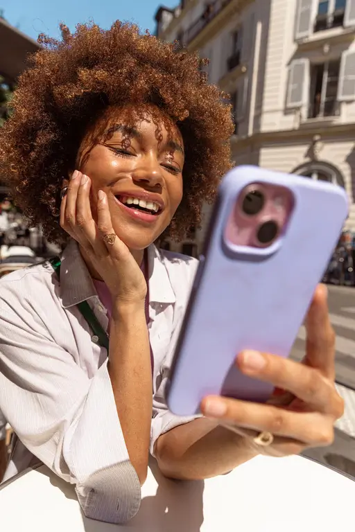 lady checking her phone and smiling