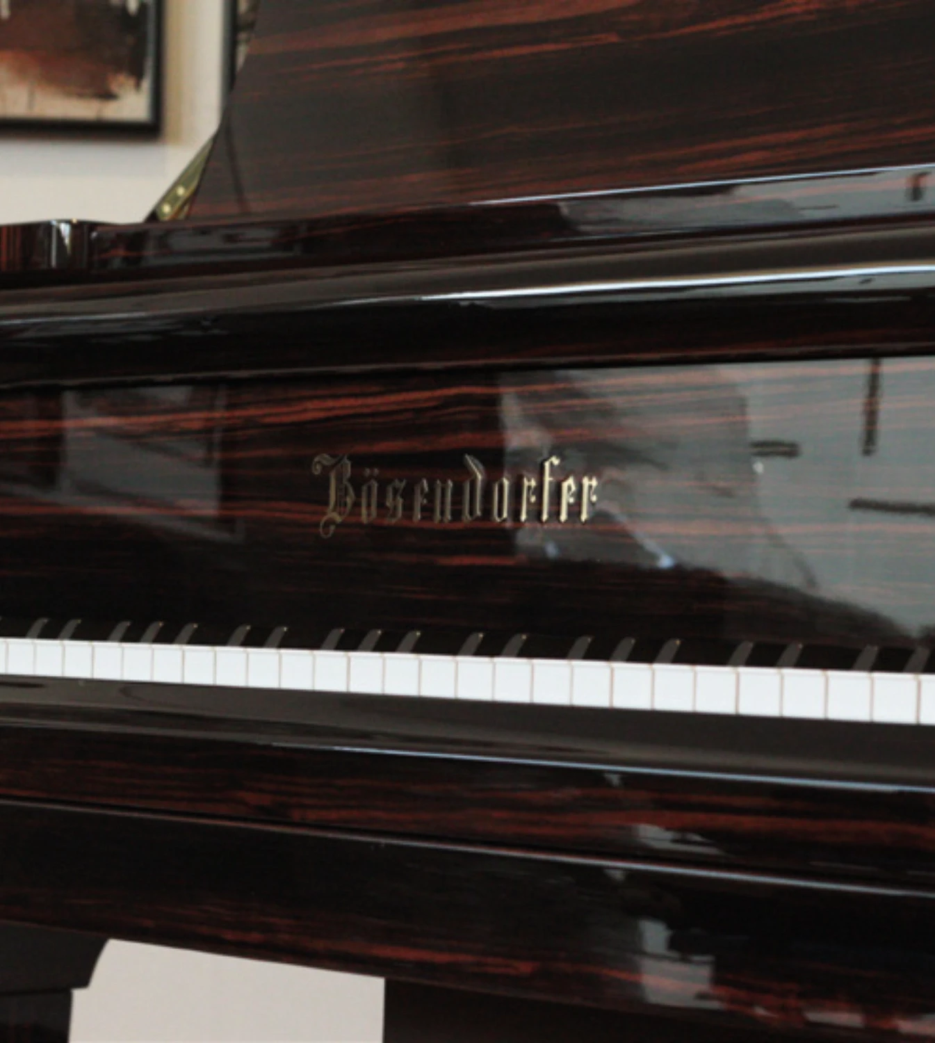 Close-up of the piano’s keyboard, showcasing perfectly polished keys and exquisite wood detailing.