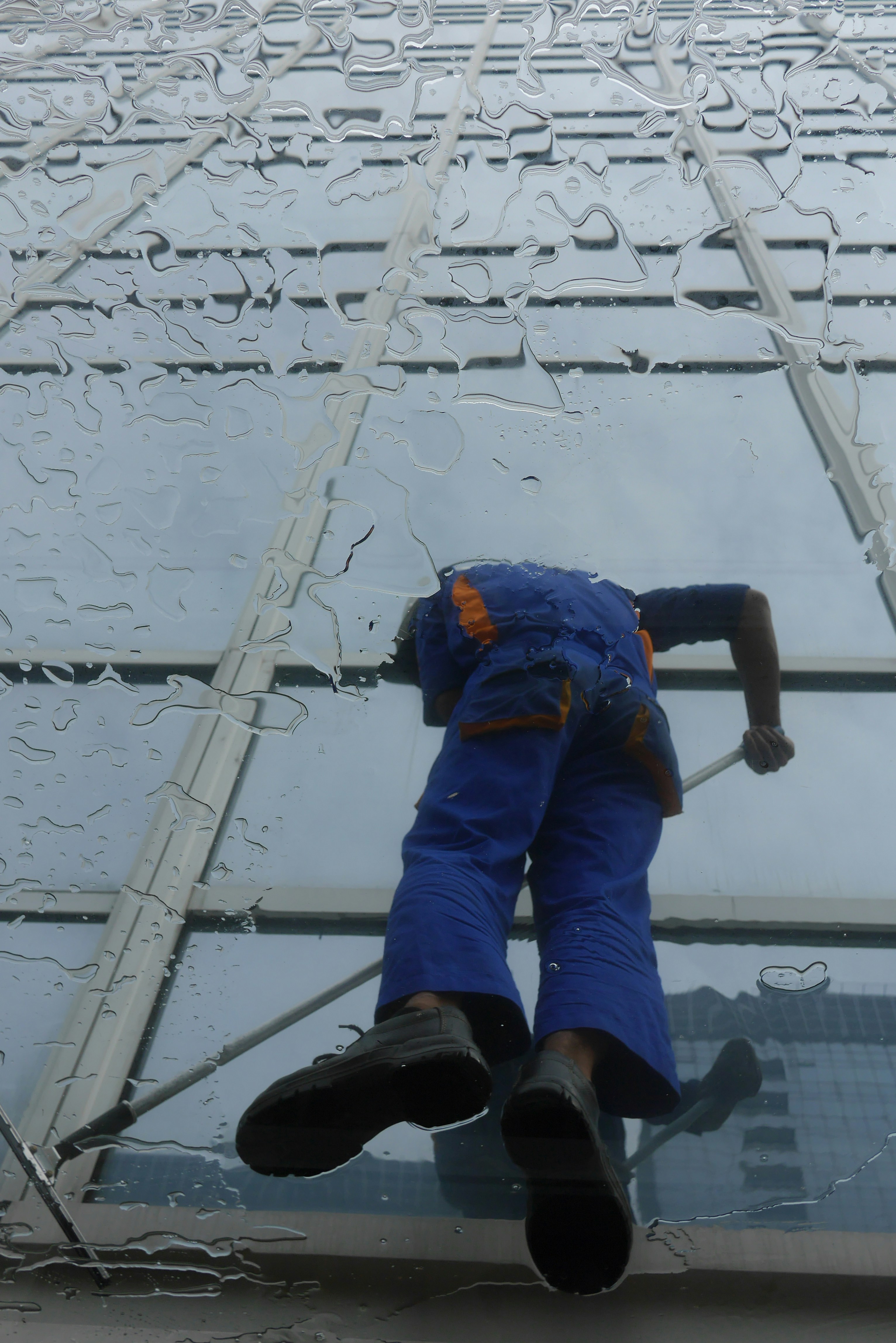 Window cleaner working on a glass building exterior