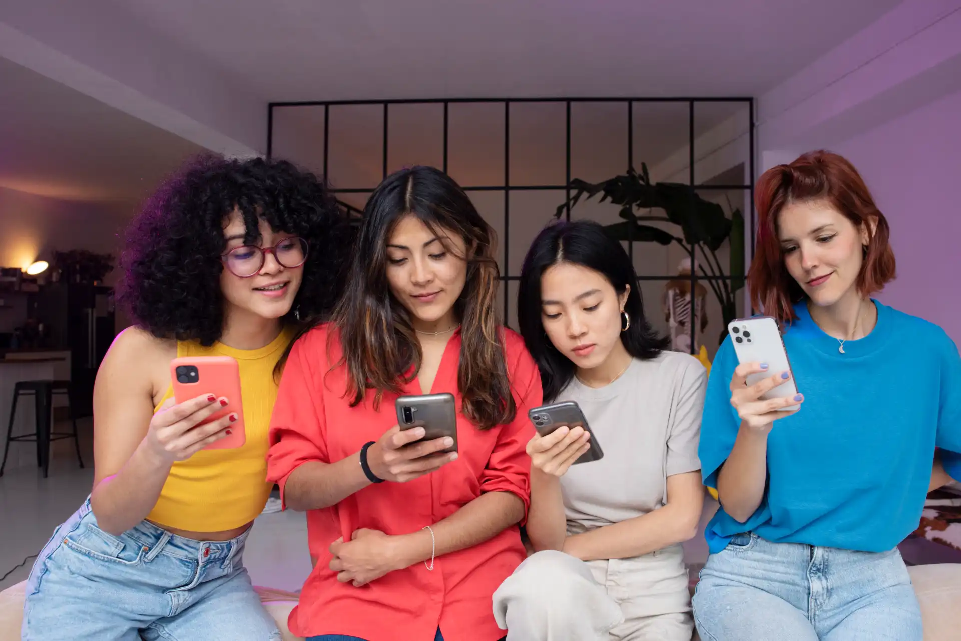 Four diverse creators scrolling TikTok on phones, demonstrating community engagement and user interaction with platform content