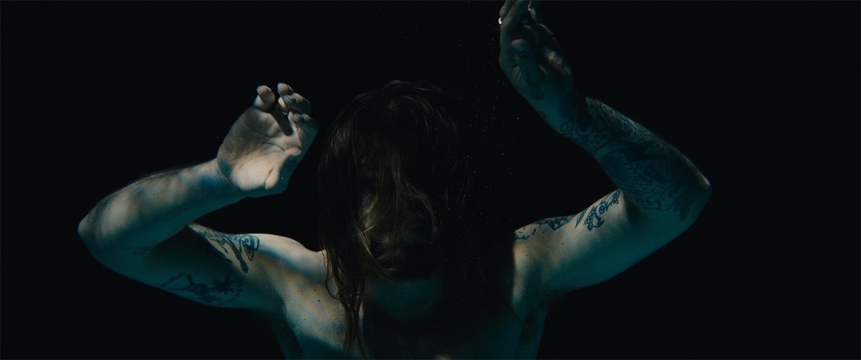 Guy floating in dark water