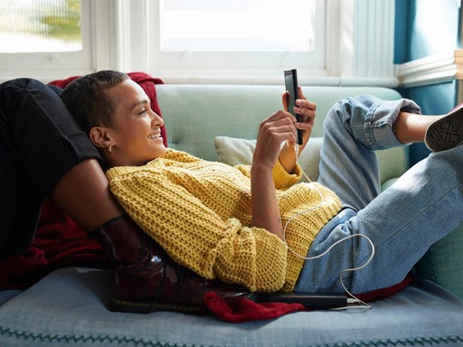 Lady on a couch using a phone