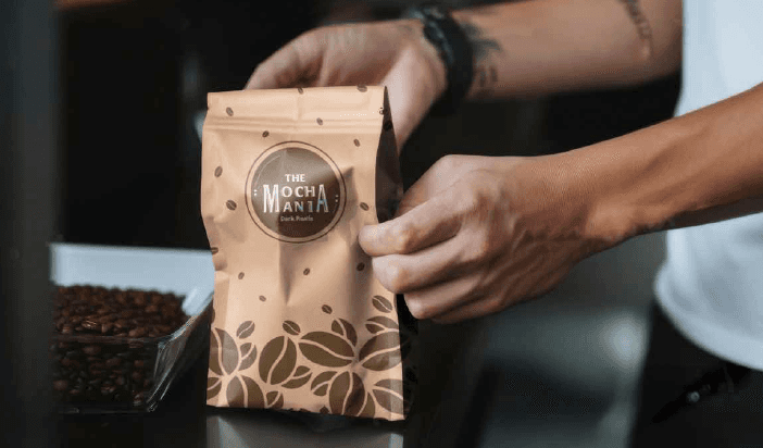 Person holding a mocha mania package