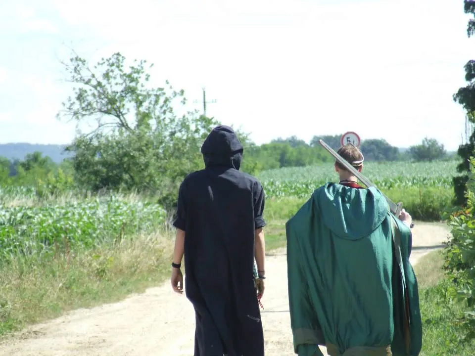 brown wooden round table with brown leather boots