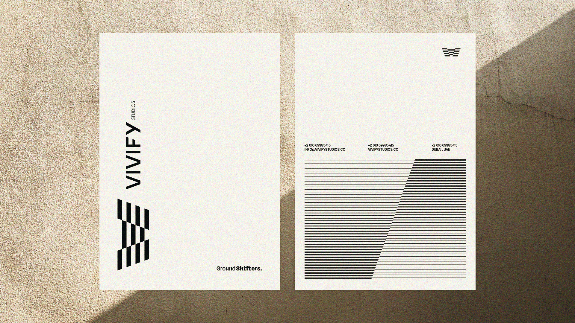 VIVIFY cream stationery with vertical branding and geometric gray panels.