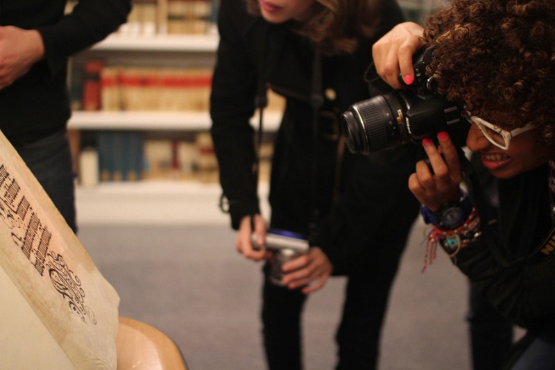 student taking photo of a old book