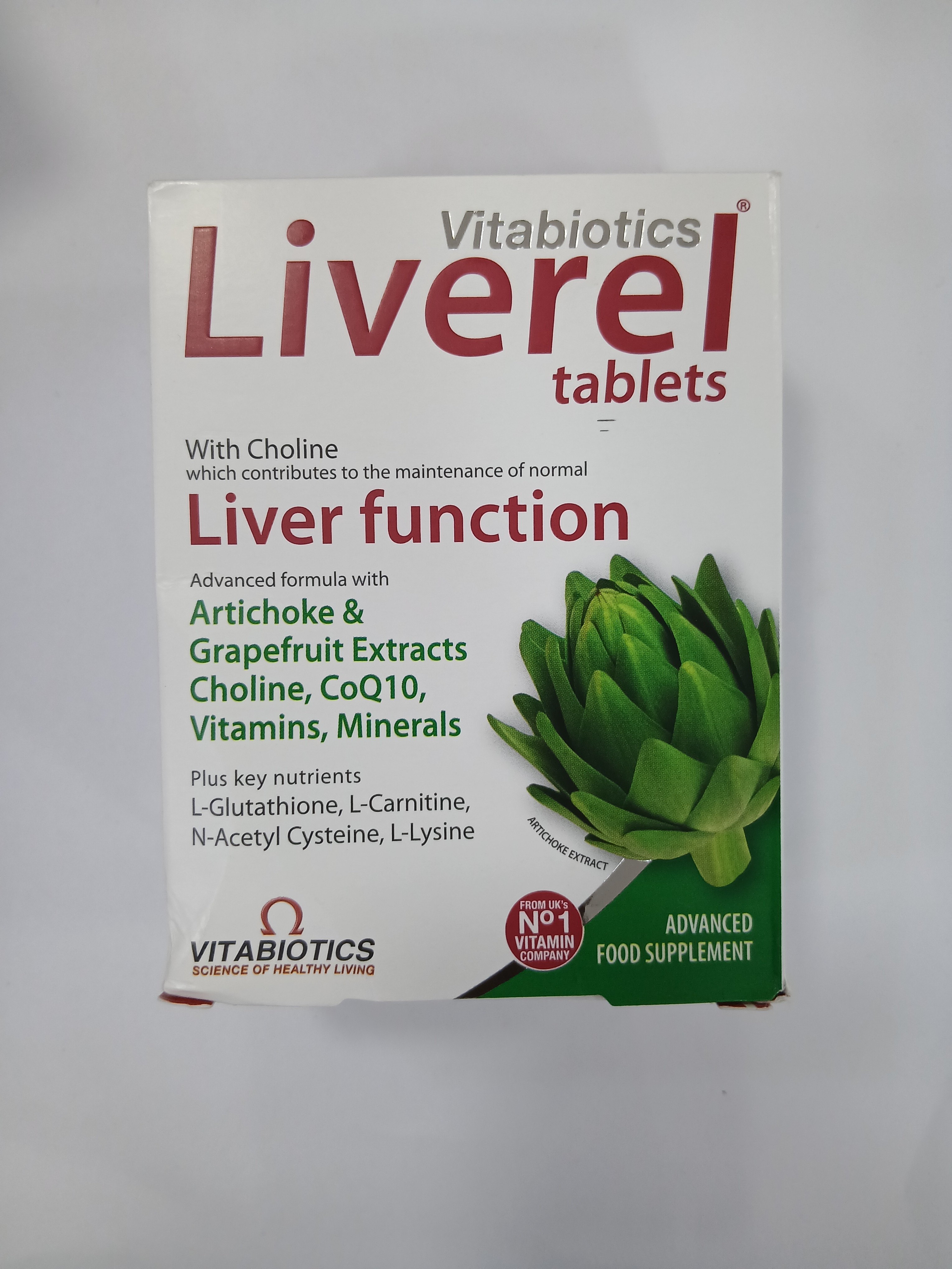 White cardboard box packaging displays a green artichoke graphic and lists ingredients and benefits for supporting liver function in black and red text.