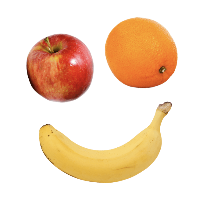 An apple, an orange, and a banana arranged to resemble a smiley face against a white background.