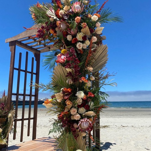 A table with plates , glasses , and flowers on it.