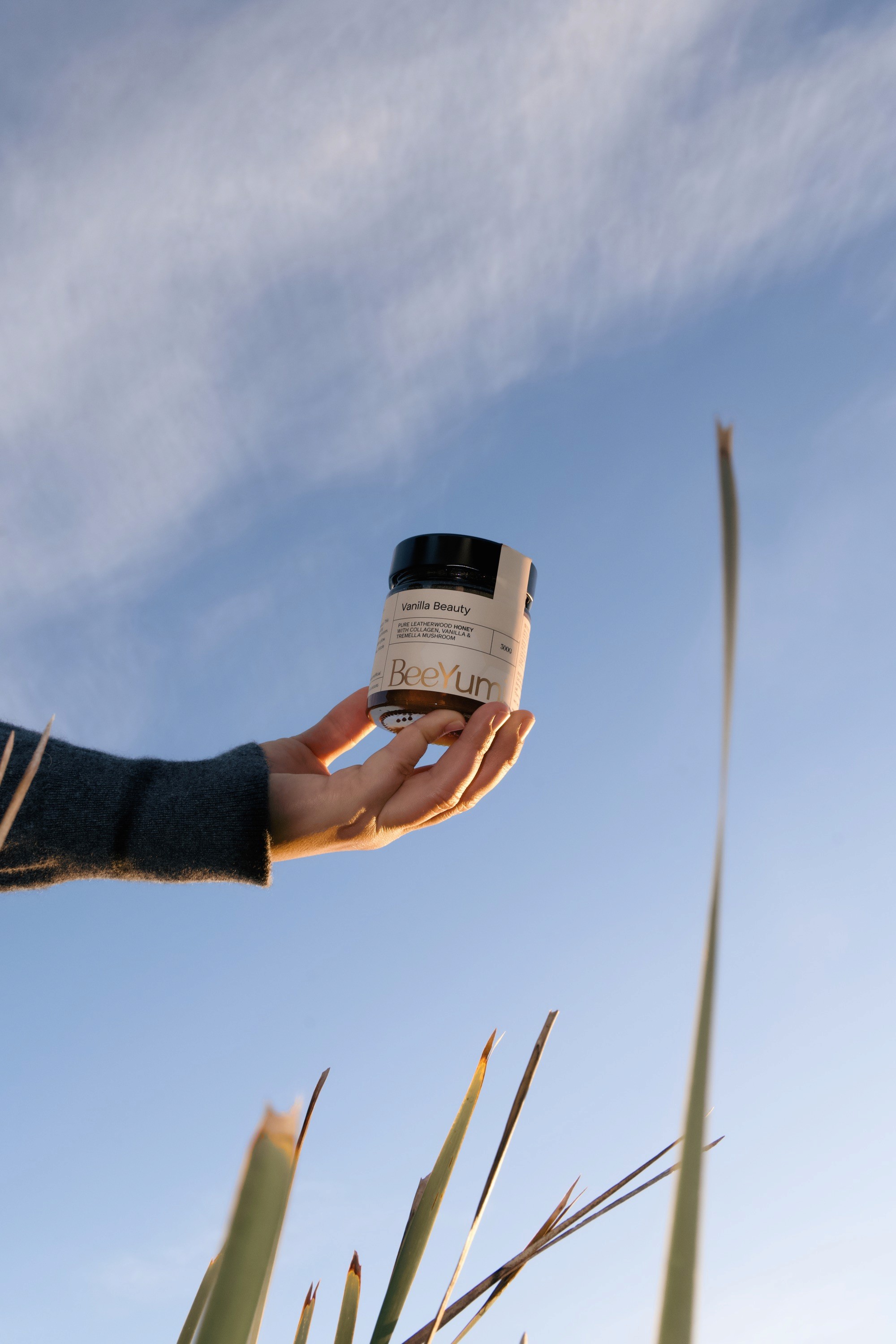 A woman with white blouse hugging jars of gummy