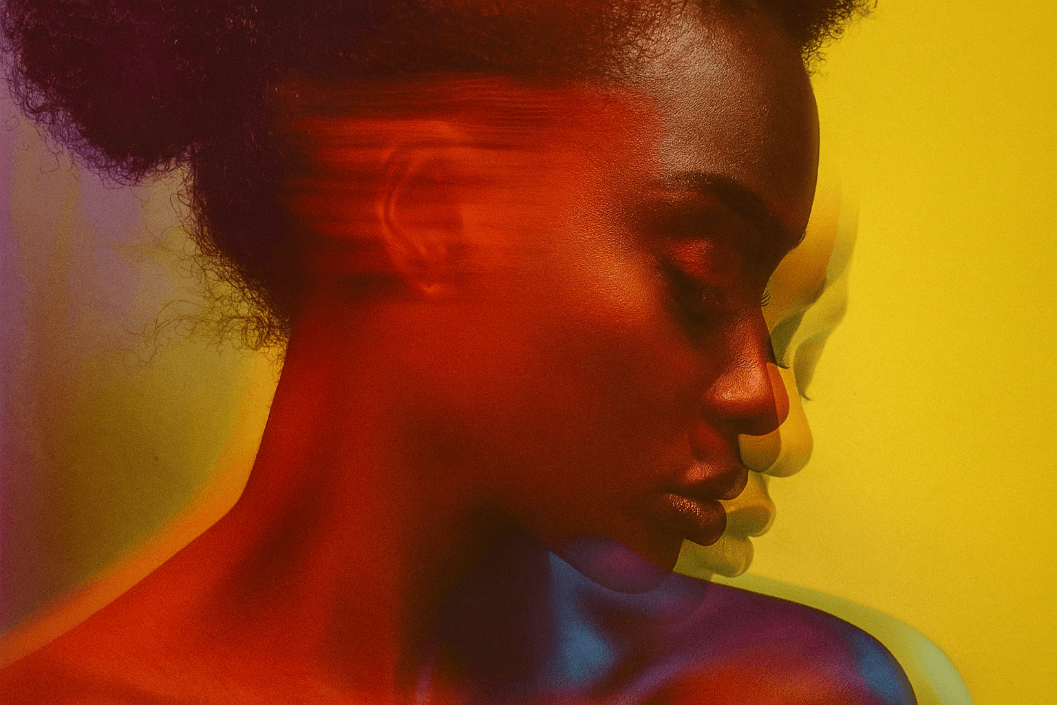 Artistic portrait with red and blue lighting creating a dramatic effect