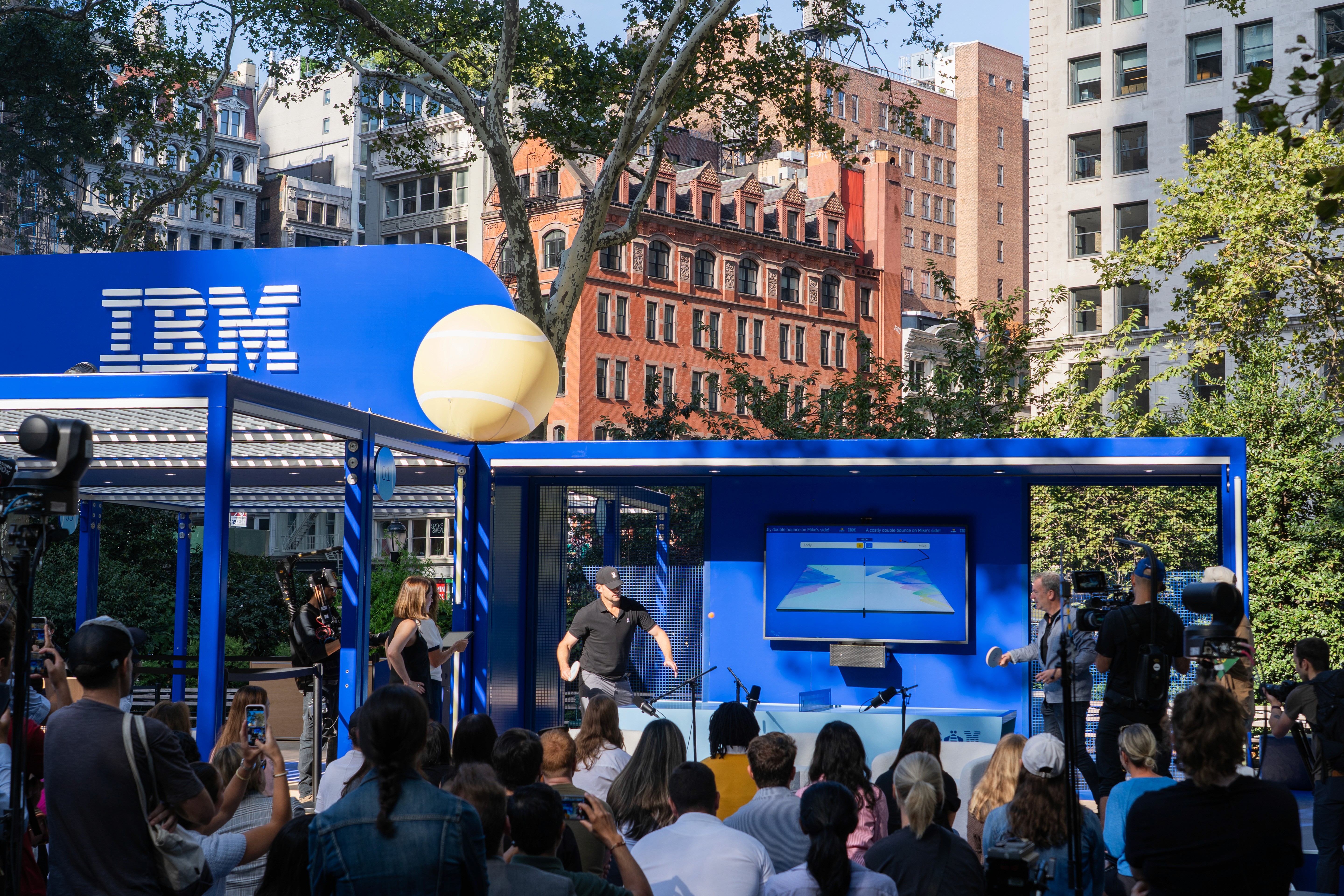 Close-up of hand holding pink ice cream cone against pastel background