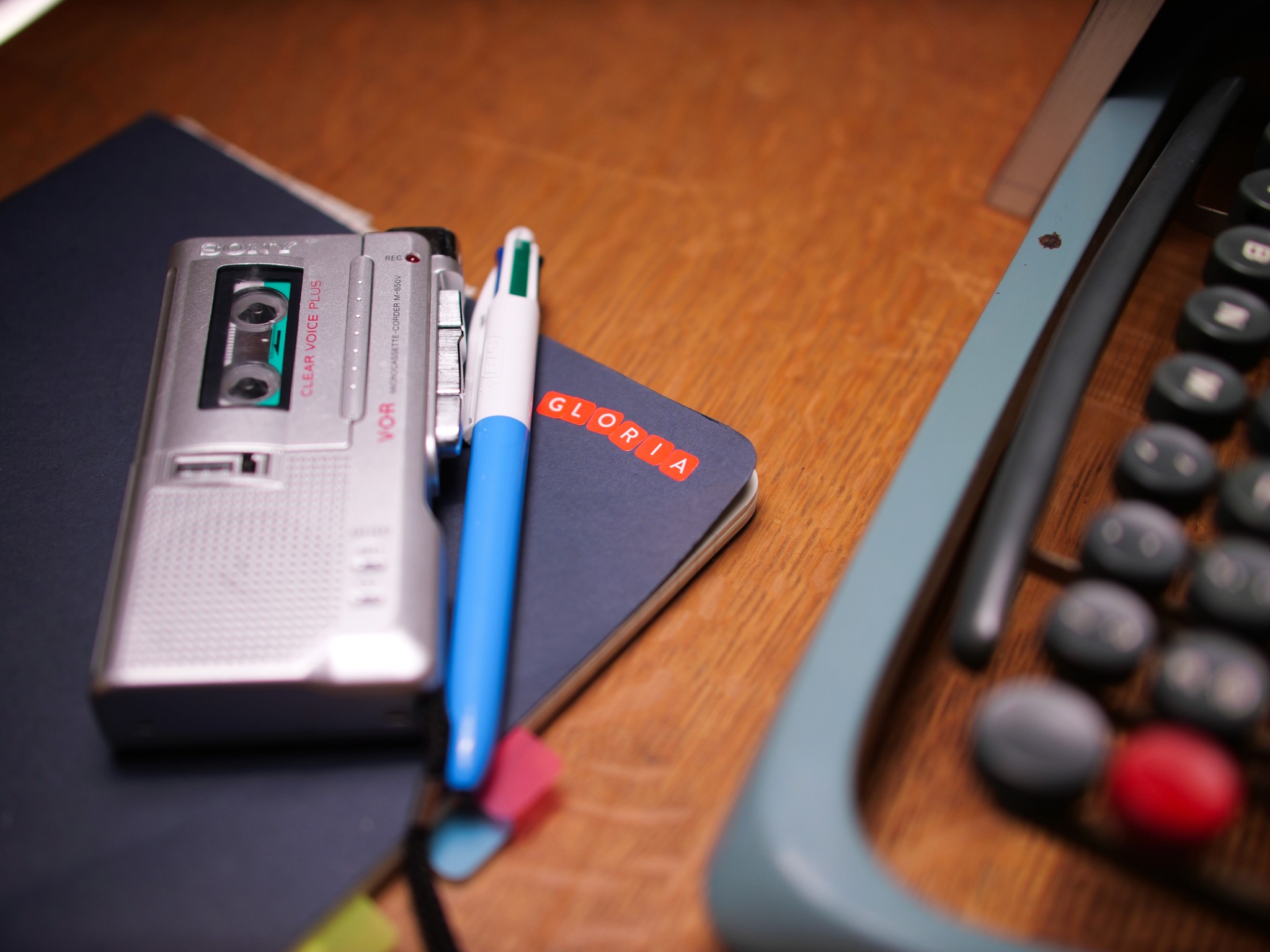 Stone kitchen with cabinets, exposed beam ceiling, terracotta floors.