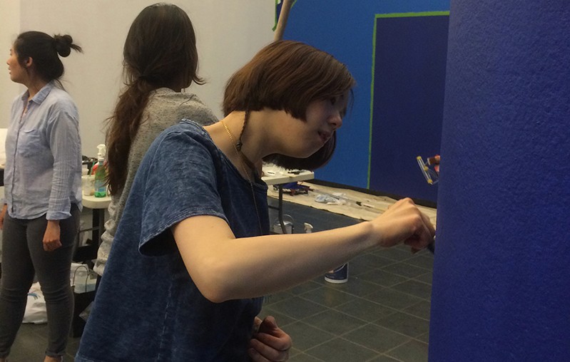 people preparing the exhibition gallery
