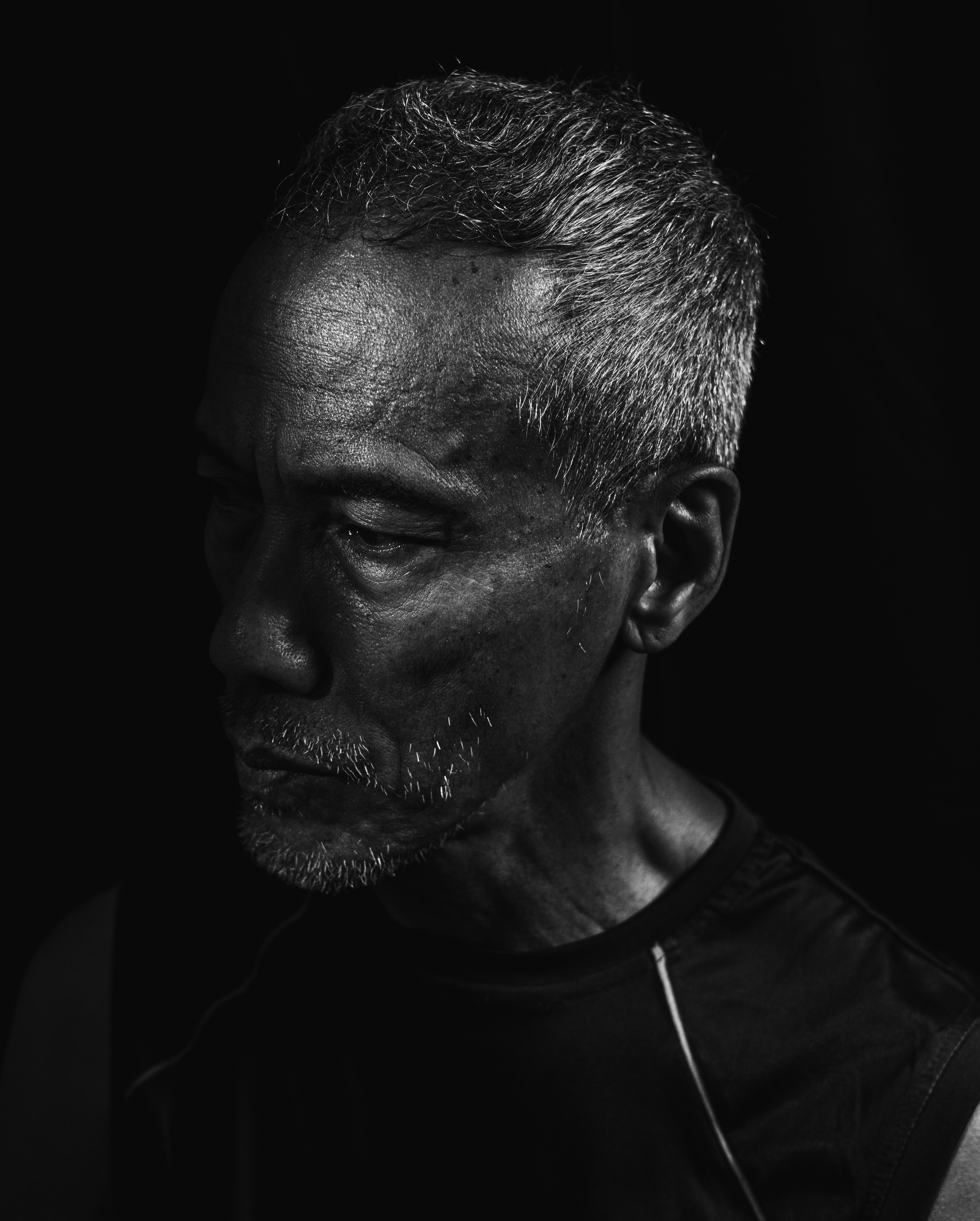 A black and white photo of a man in a black shirt